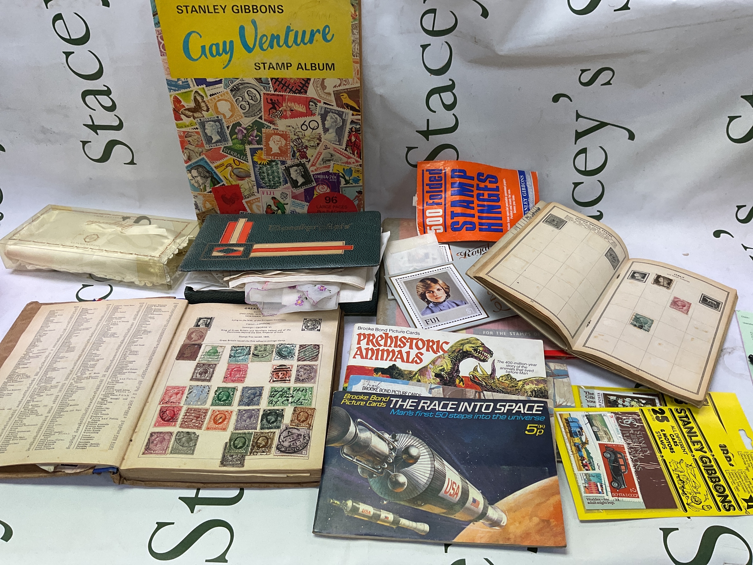 qty stamp albums and tea cards and ephemera.