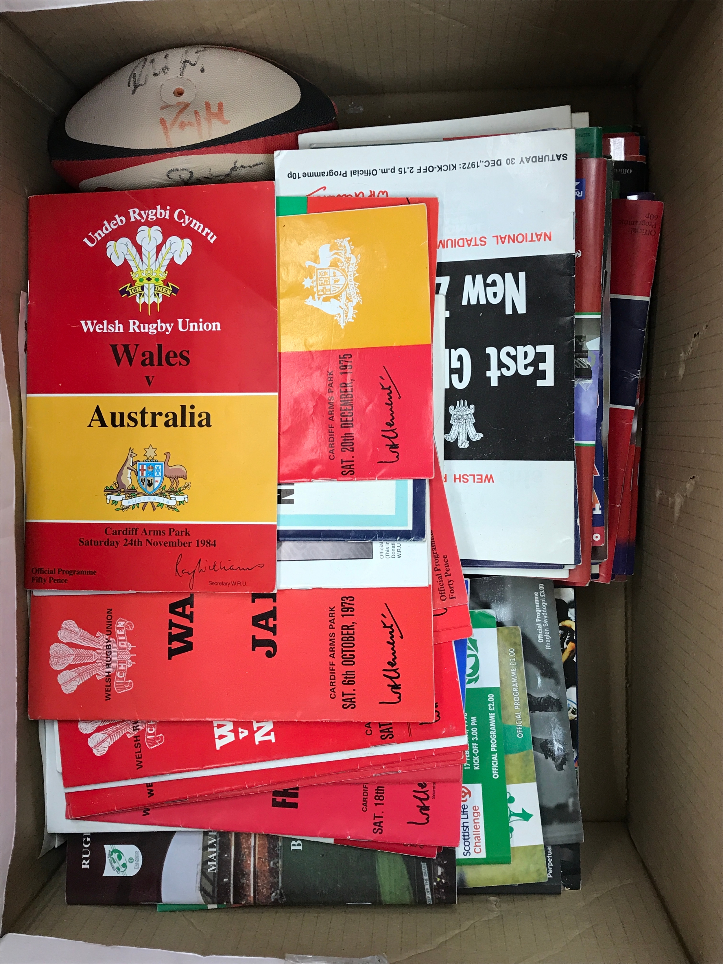 A collection of 135 rugby Union programmes , mainly wales home games from 1960-2000 including games against Australia, New Zealand, South Africa, Argentina, Japan, England etc together with a mini ball signed by at least one all black player, no revere 