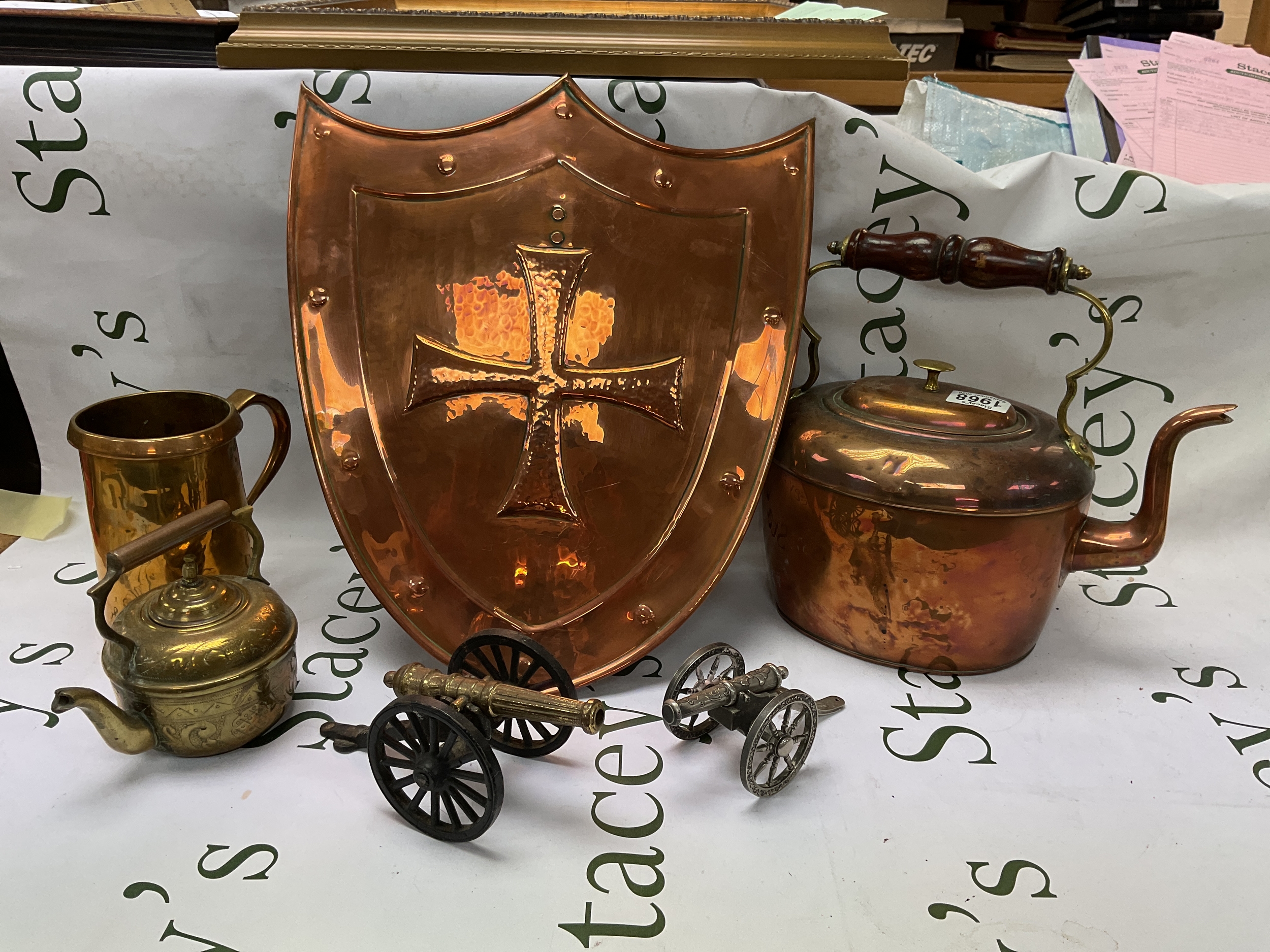 Qty of brass to inc shield, kettle, quart pot and two cannons.