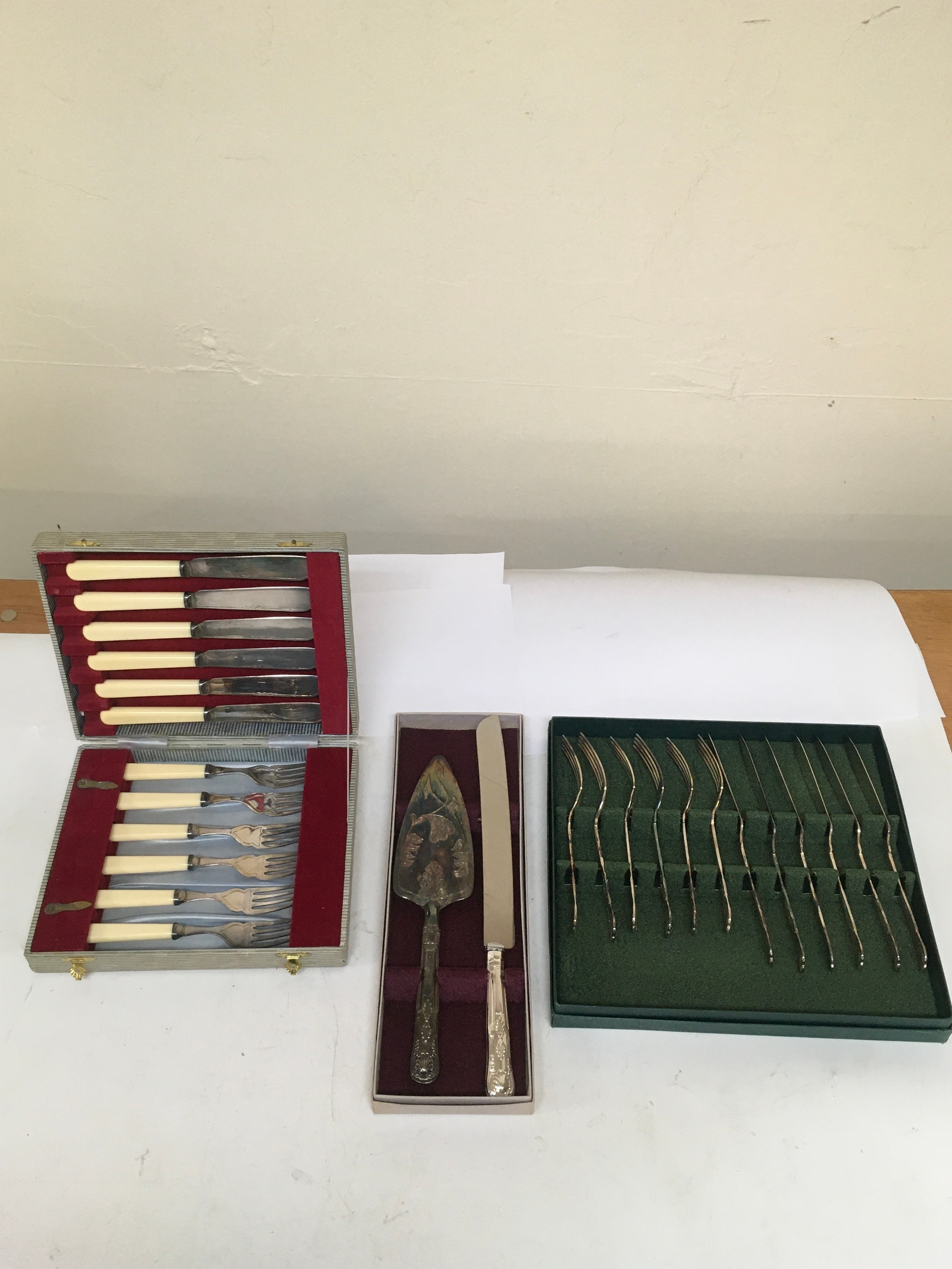 2 sets of stainless steel Knives and forks, & 1 set of cake knife and server. All 3 sets come with cases from which they were issued.  NO RESERVE