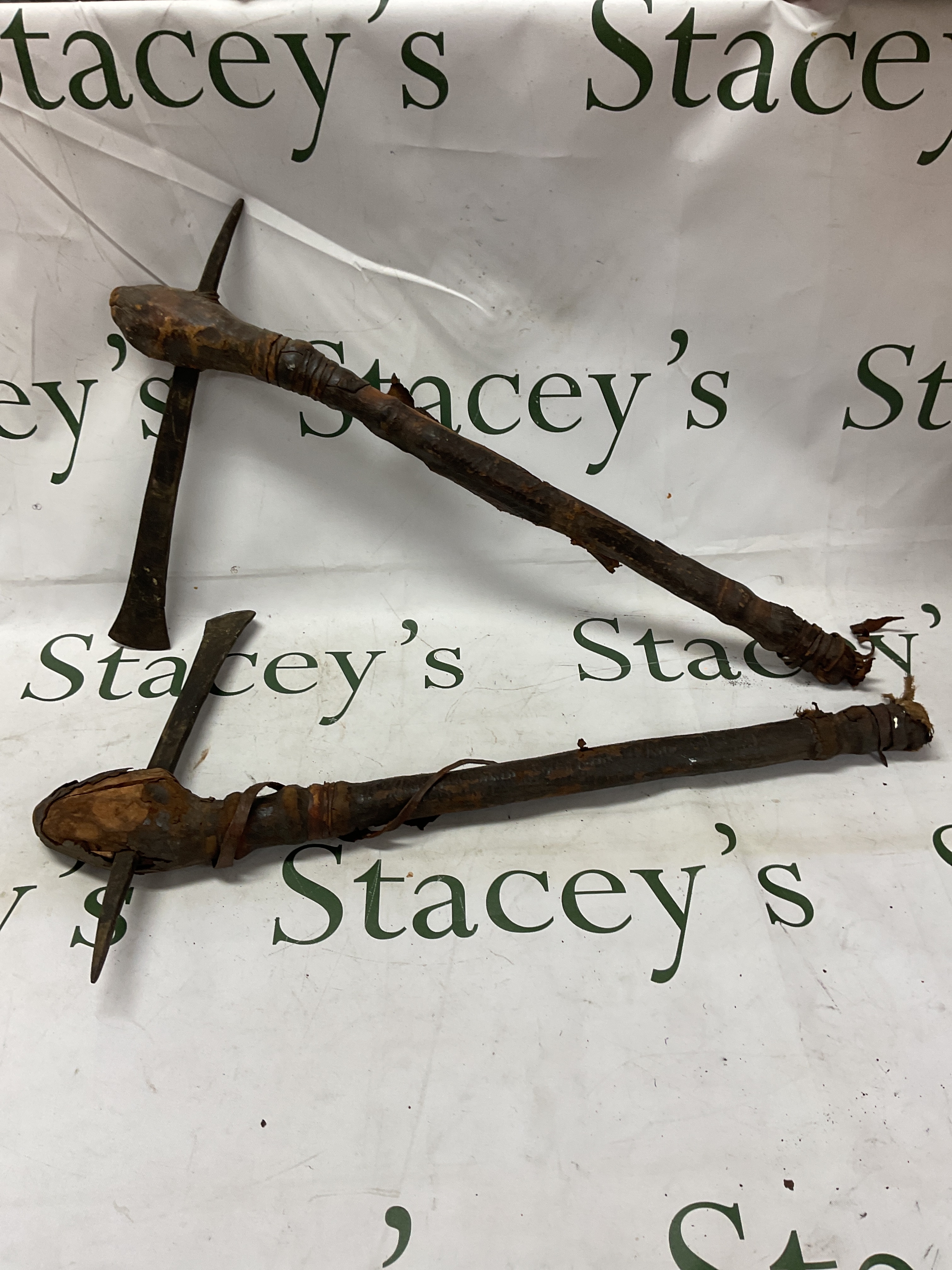 Two 19th C tribal throwing axes with spike and slim edge in leather covered wood handles  NO RESERVE