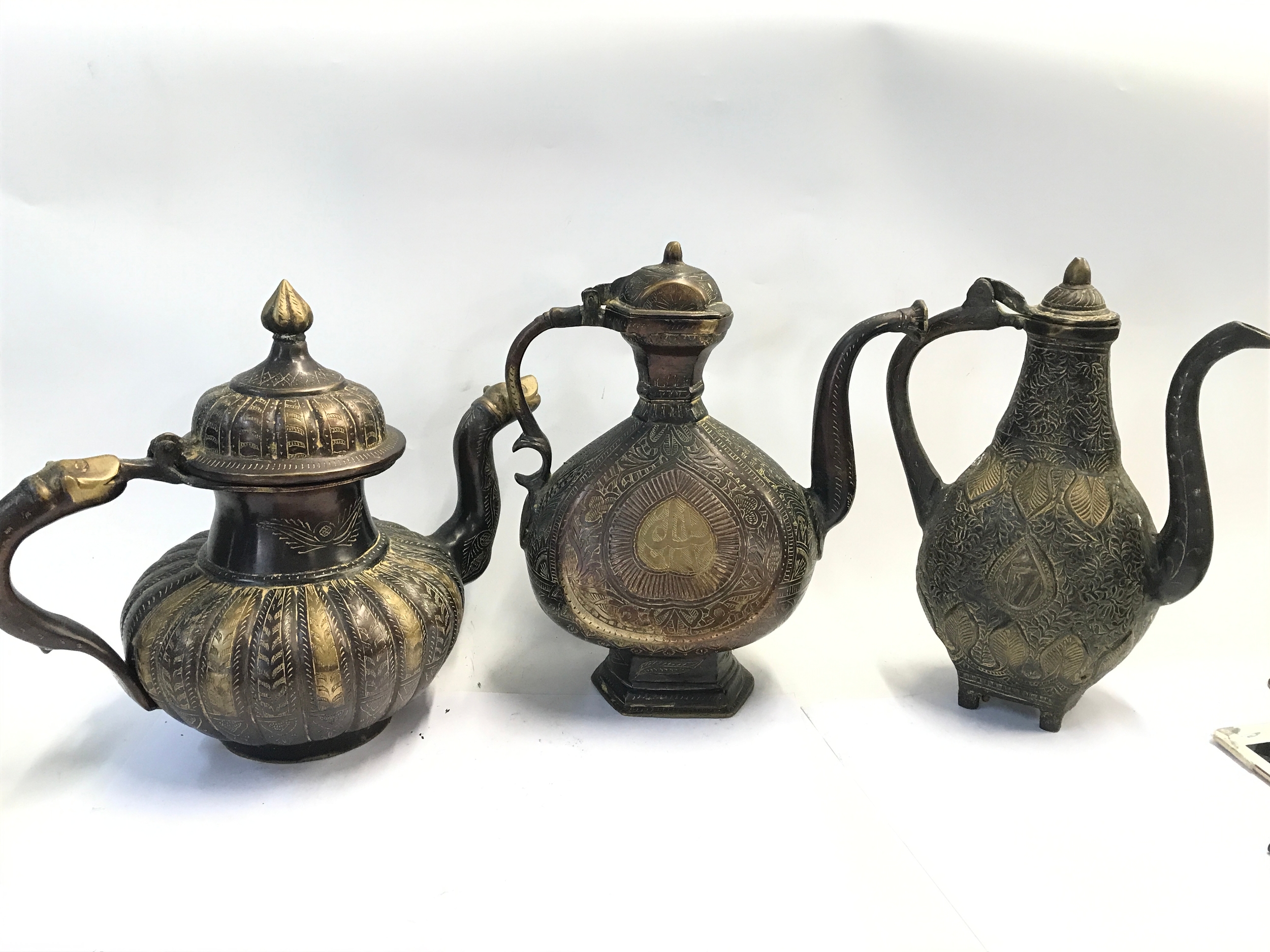 Three bronze ewers. 29 to 31cm tall  NO RESERVE