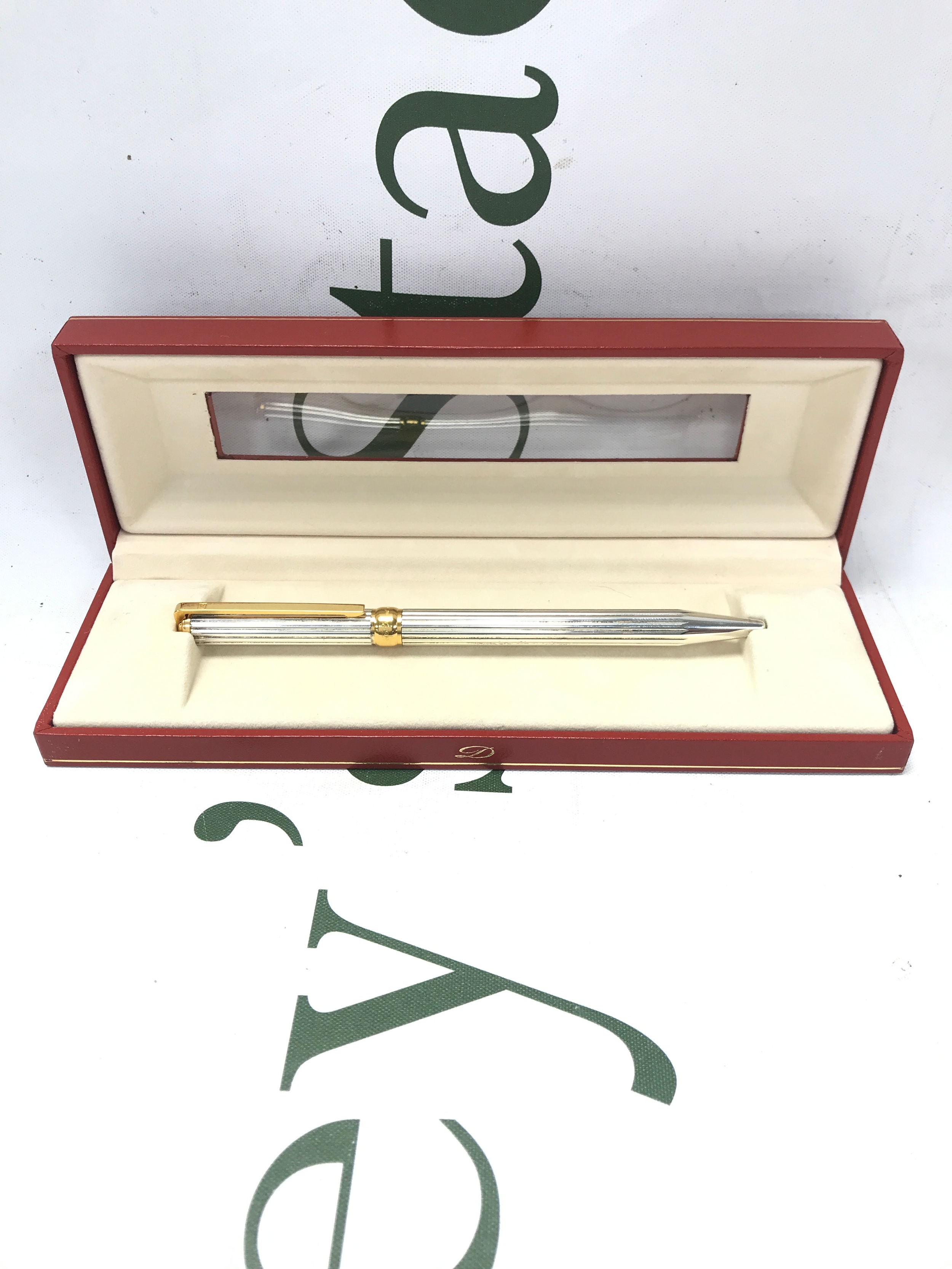 A boxed silvered DuPont pen.