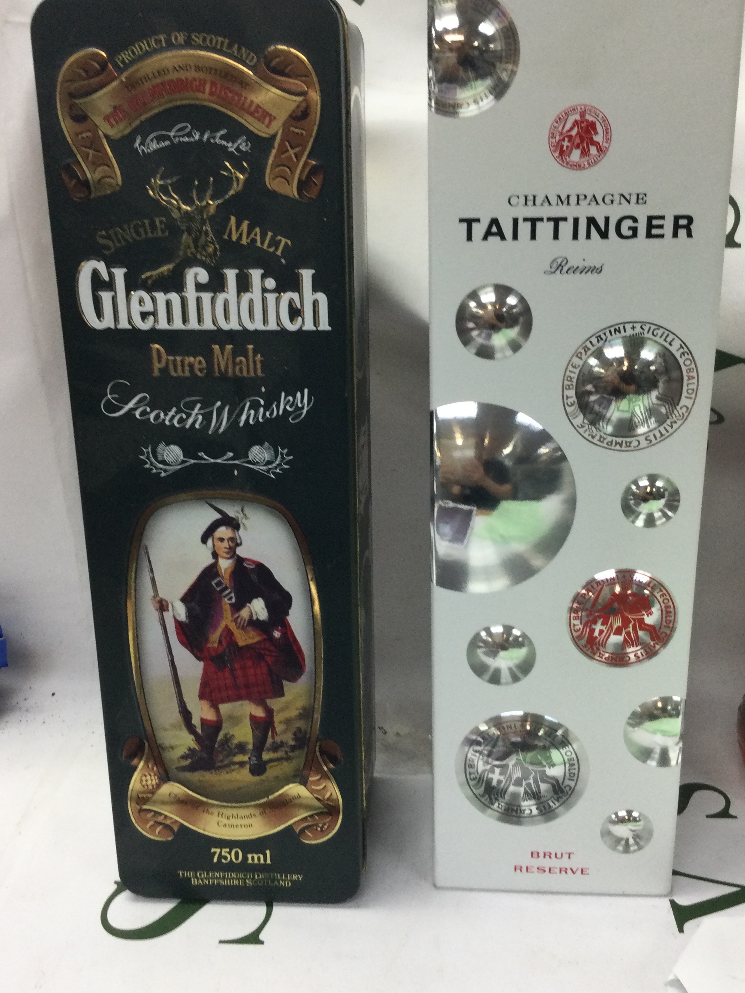 A Taittinger champagne and a bottle of Glenfiddich 