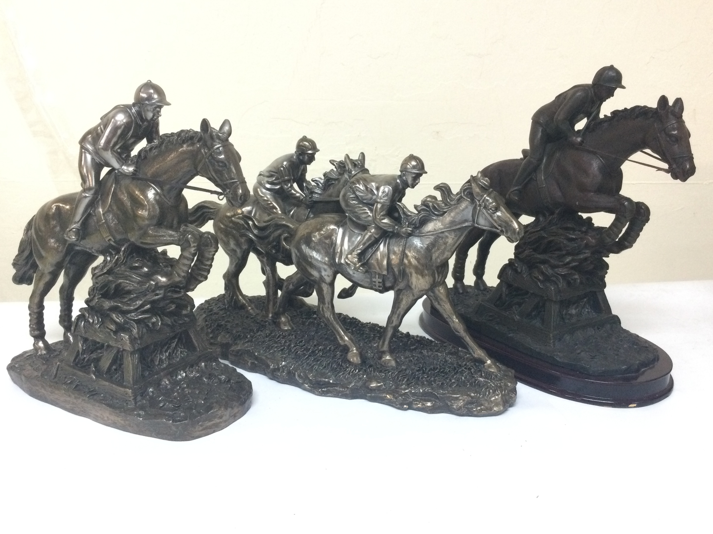 Three horse figures 19 and 25cm tall