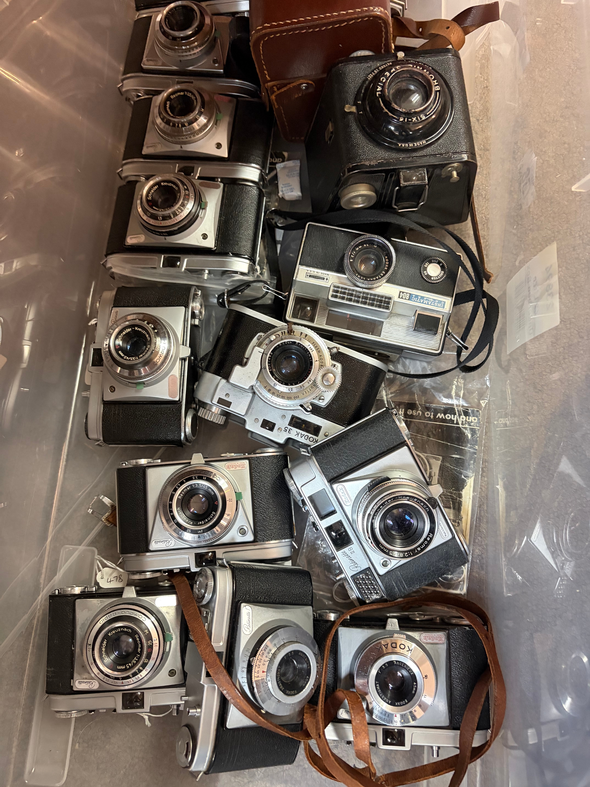 A collection of various Kodak cameras together with various accessories and empty camera holsters no reserve