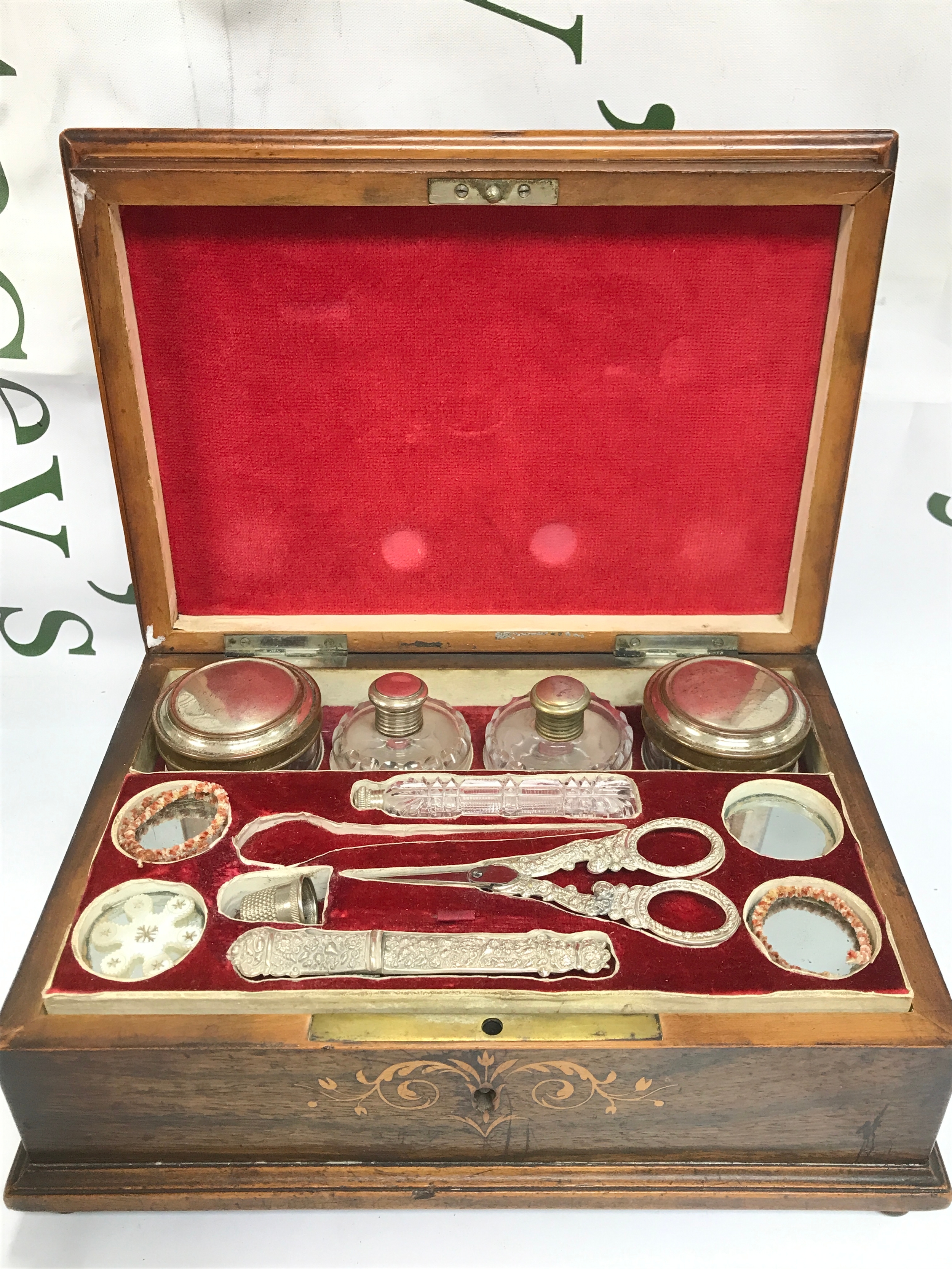 An Edwardian sewing box with a well fitted interior. Dimensions 24cm wide 27cm long 10cm tall