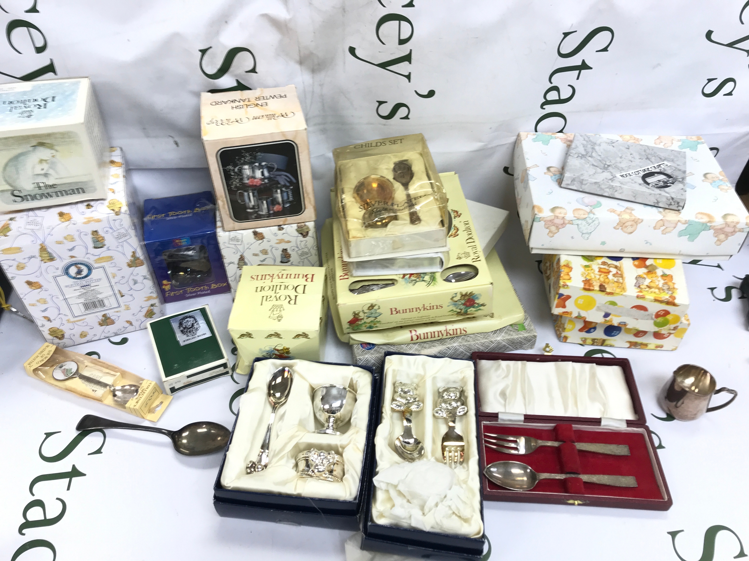 A quantity or christening gifts to include silver frame and cutlery, bunnykins items
