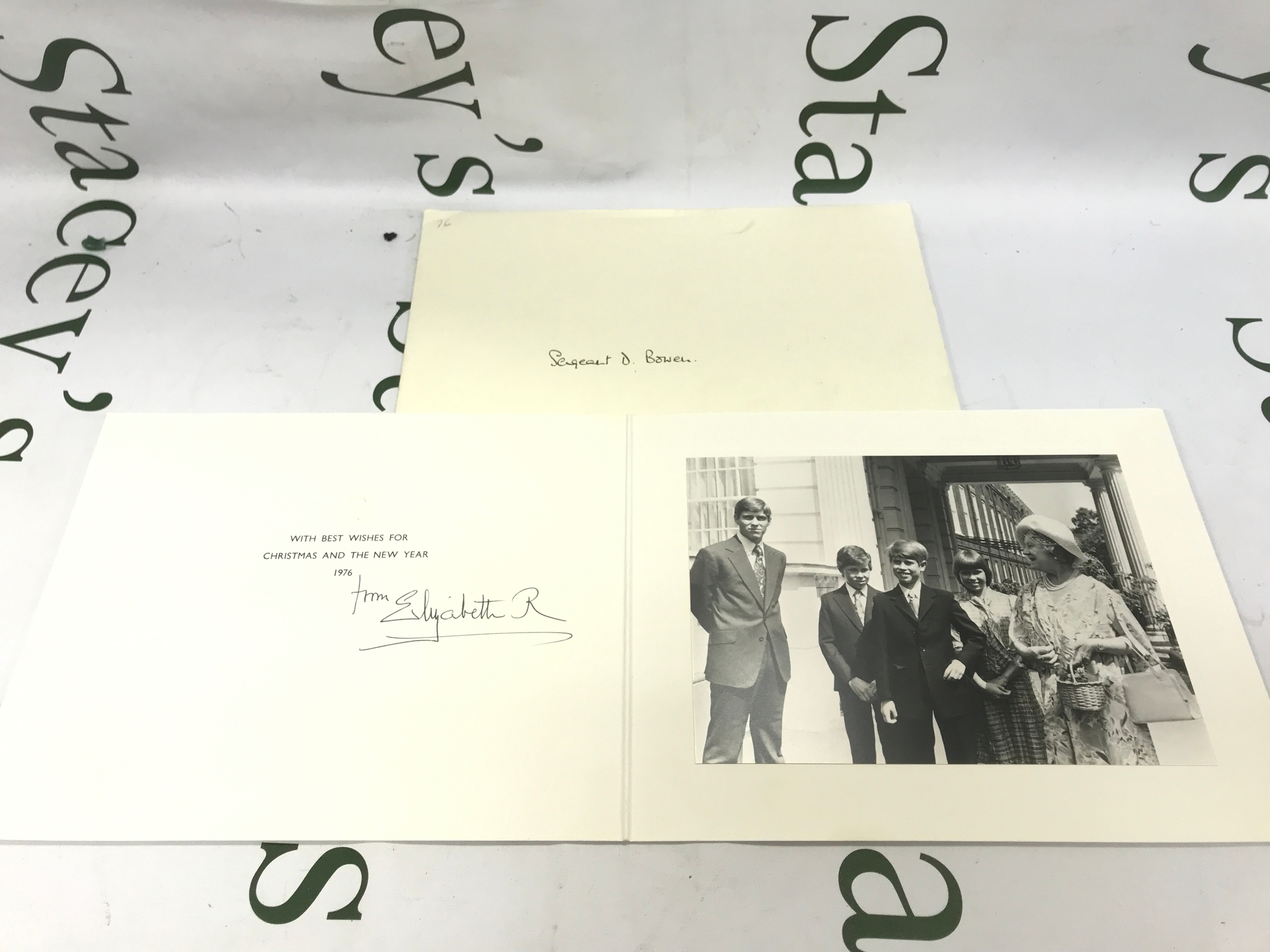 H.M. Queen Elizabeth The Queen Mother 1900-2002, signed Christmas and New Year card dated 1976, with gilt cypher to cover, the interior with black and white image of The Queen Mother with four of her grandchildren outside Clarence House, with TRHs Princes Andrew and Edward, Lady Sarah Armstrong-Jones and David, Viscount Linley, signed 'from Elizabeth R'