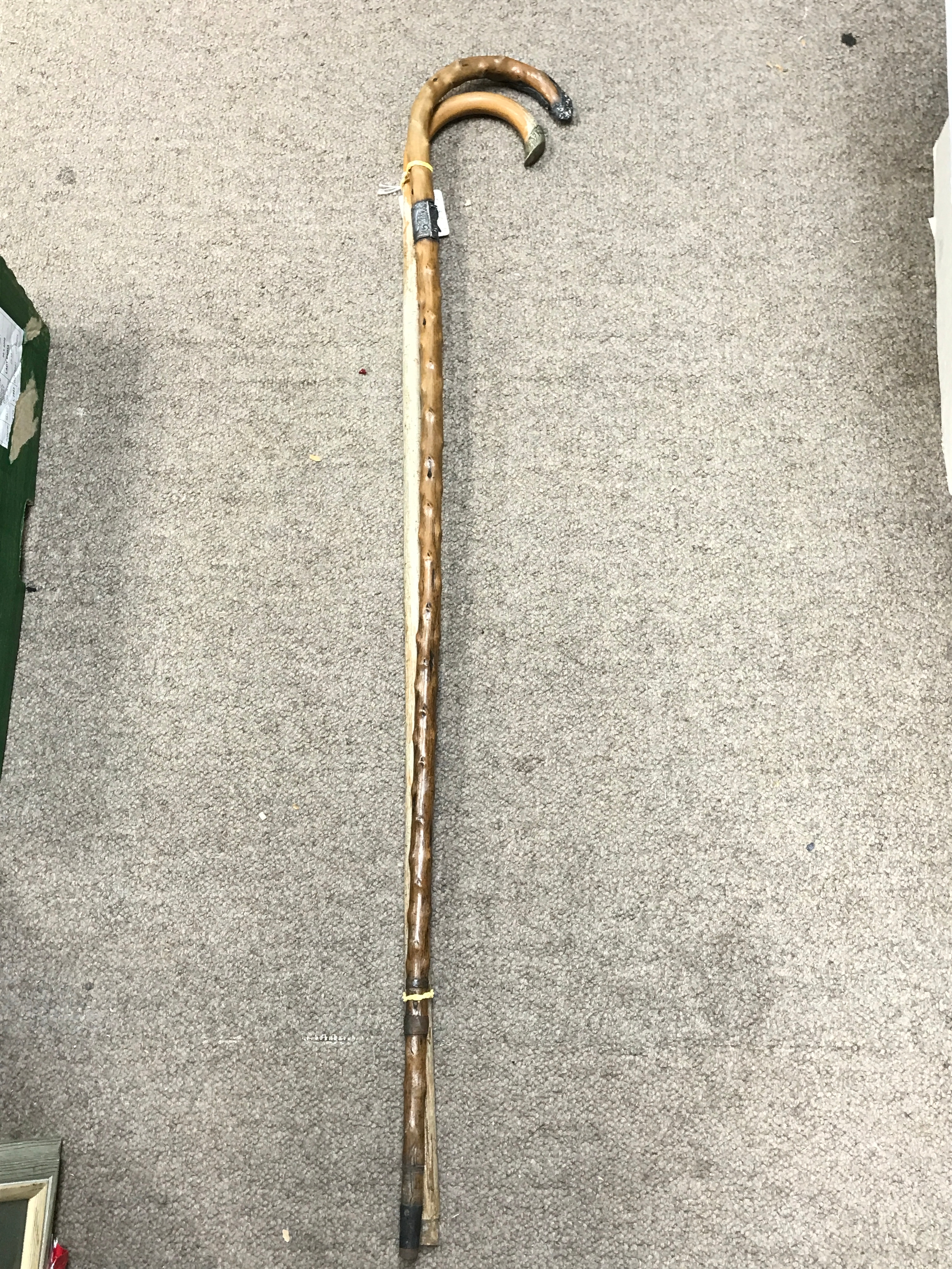 Two walking sticks with embossed metal parts, 93cm long