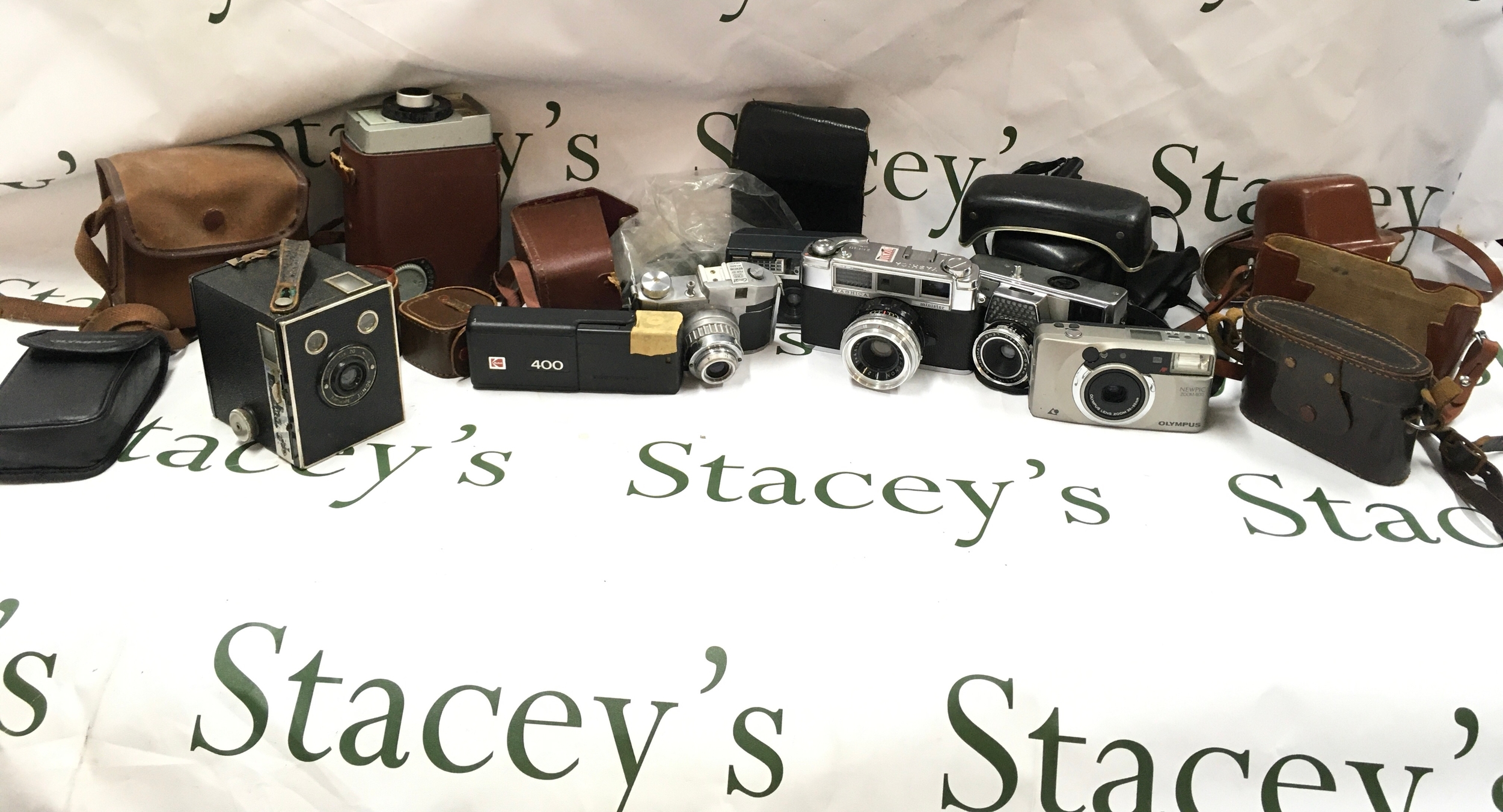 A collection of cameras and cases and other camera accessories 