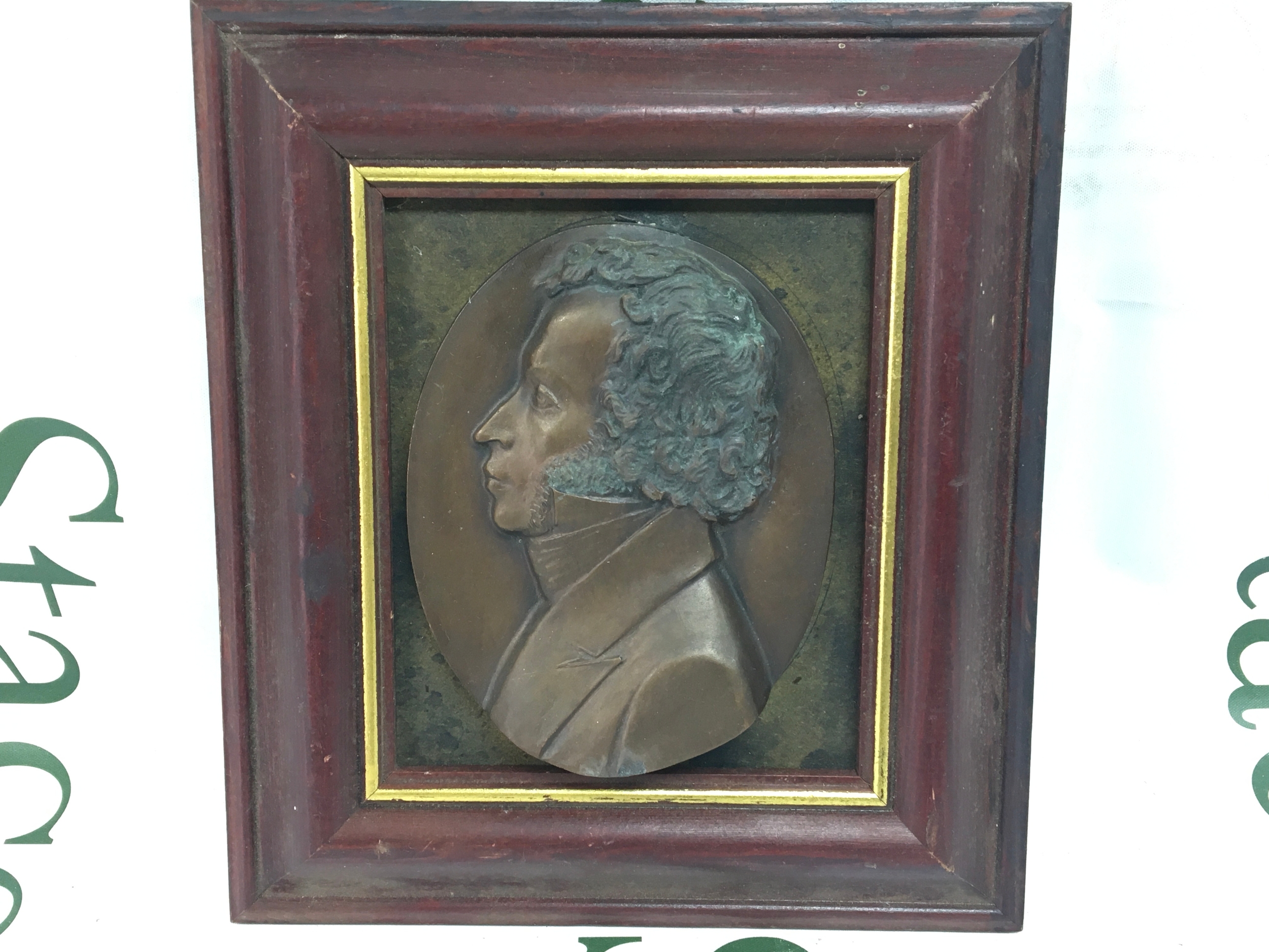 A vintage framed plaque of a Georgian head and shoulders in wooden frame 21x23cm
