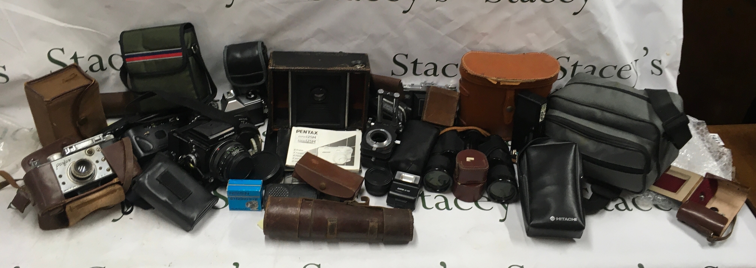 A large collection of cameras and camera equipment 