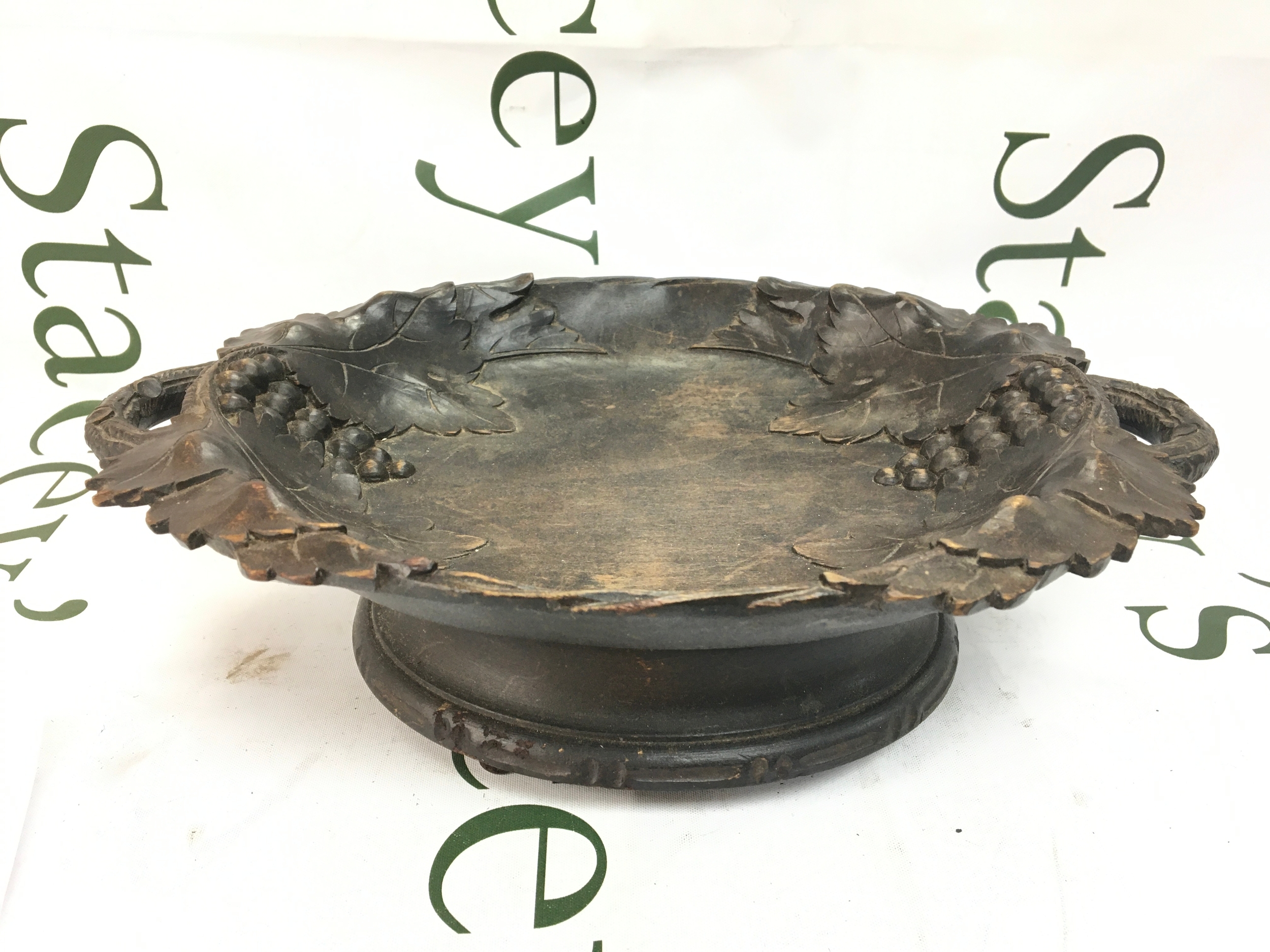An antique carved wooden music box in working order, 28cm wide