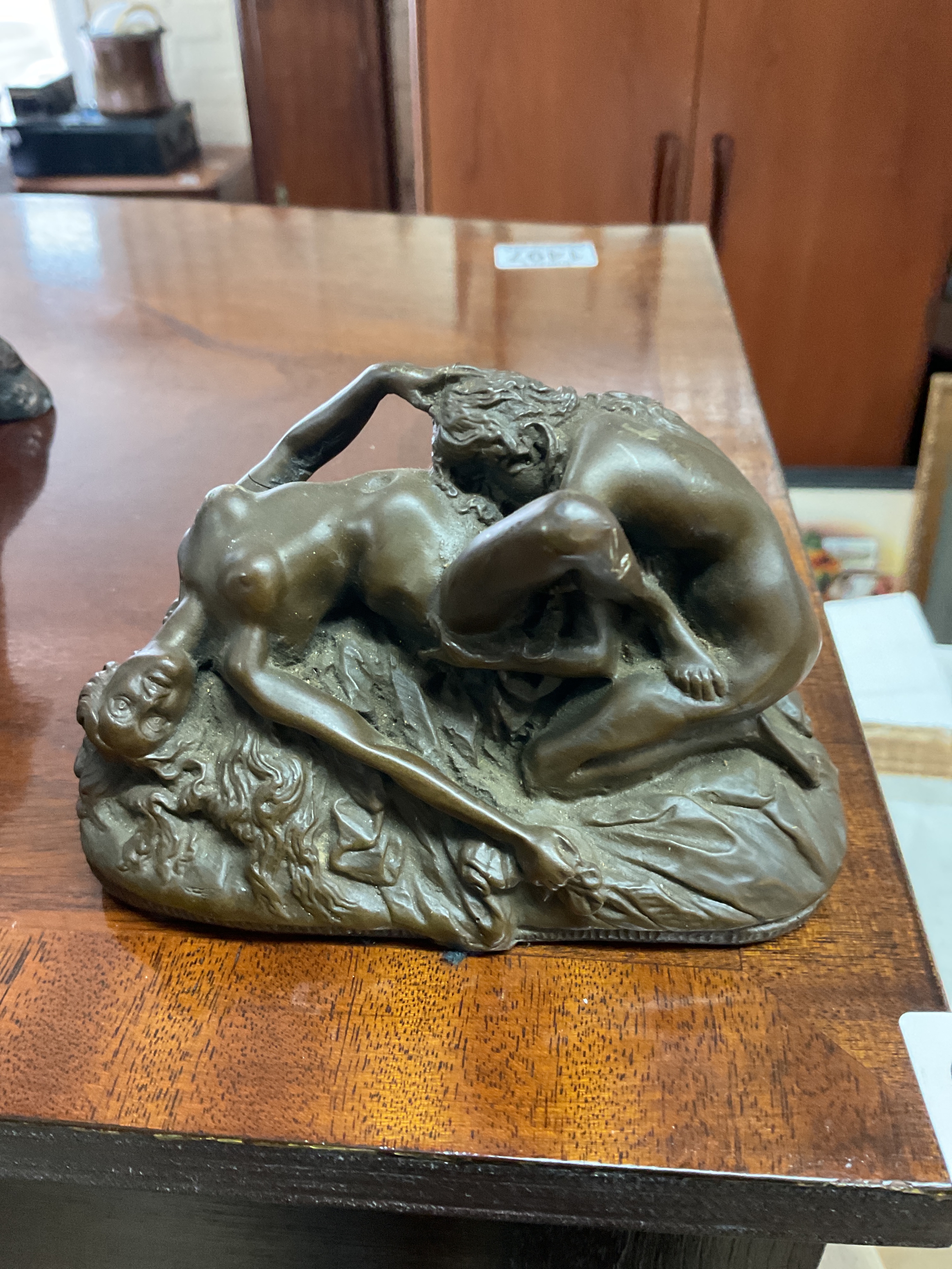 Erotic bronzed resin figure.
