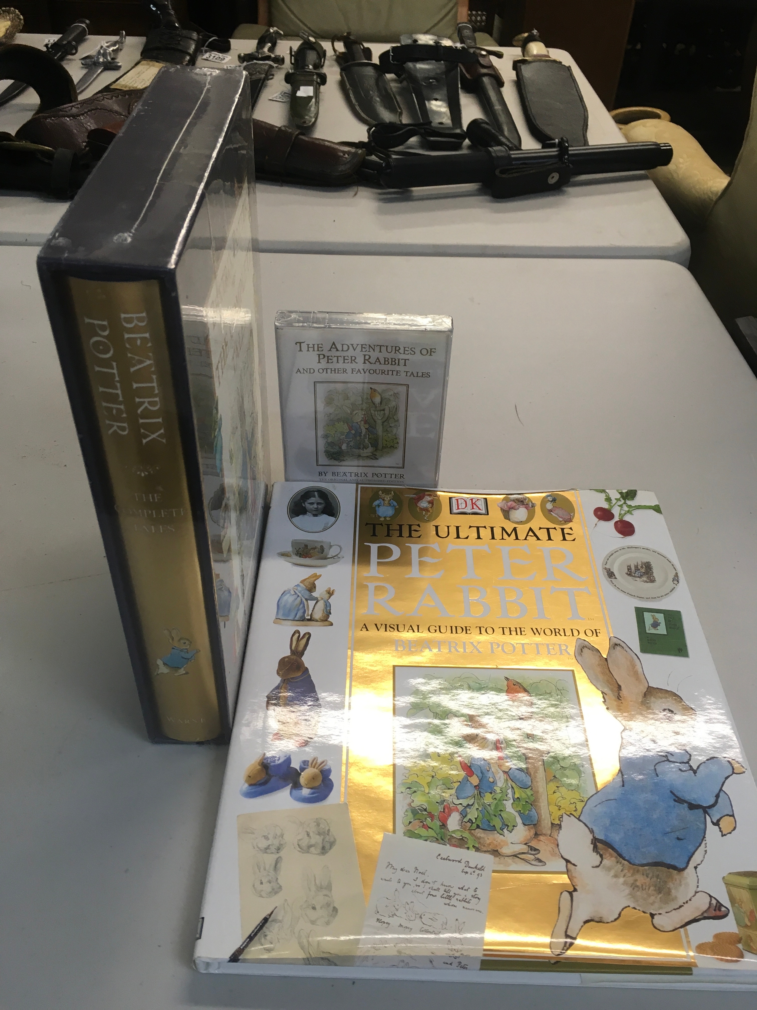 A collection of Beatrix Potter items including a visual guide, The Adventure Of Peter Rabbit and Other Favourite Tales tales, and Beatrix Potter the complete tales. 