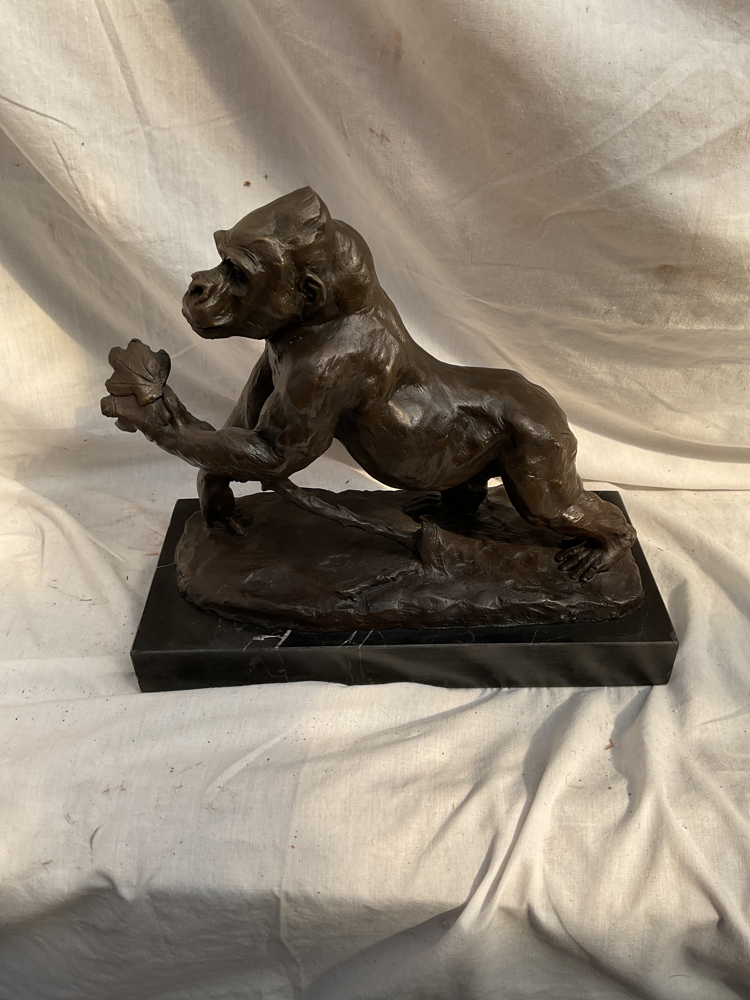 After Rembrandt Bugatti, a bronze Gorilla on marble base. H 29 cm x W 32.5 cm.