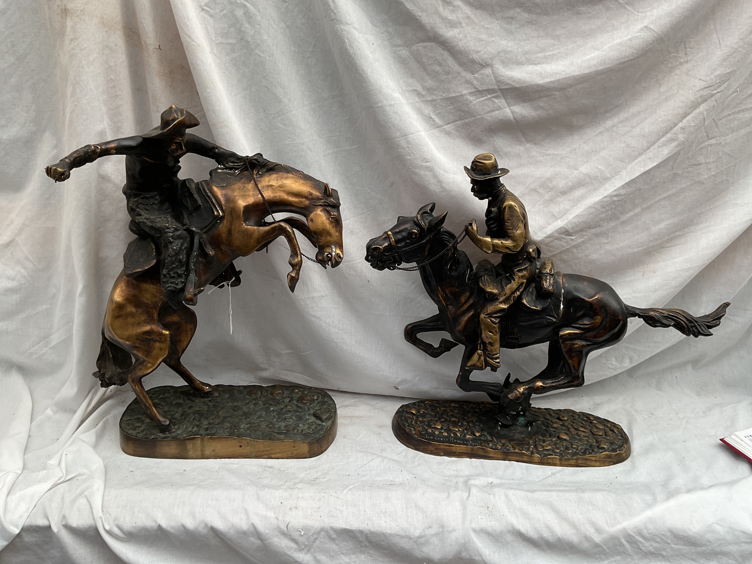 Two Frederick Remington signed bronzes of "Bronco Buster" and "Plains Drifter" H53 cm and 58 cm