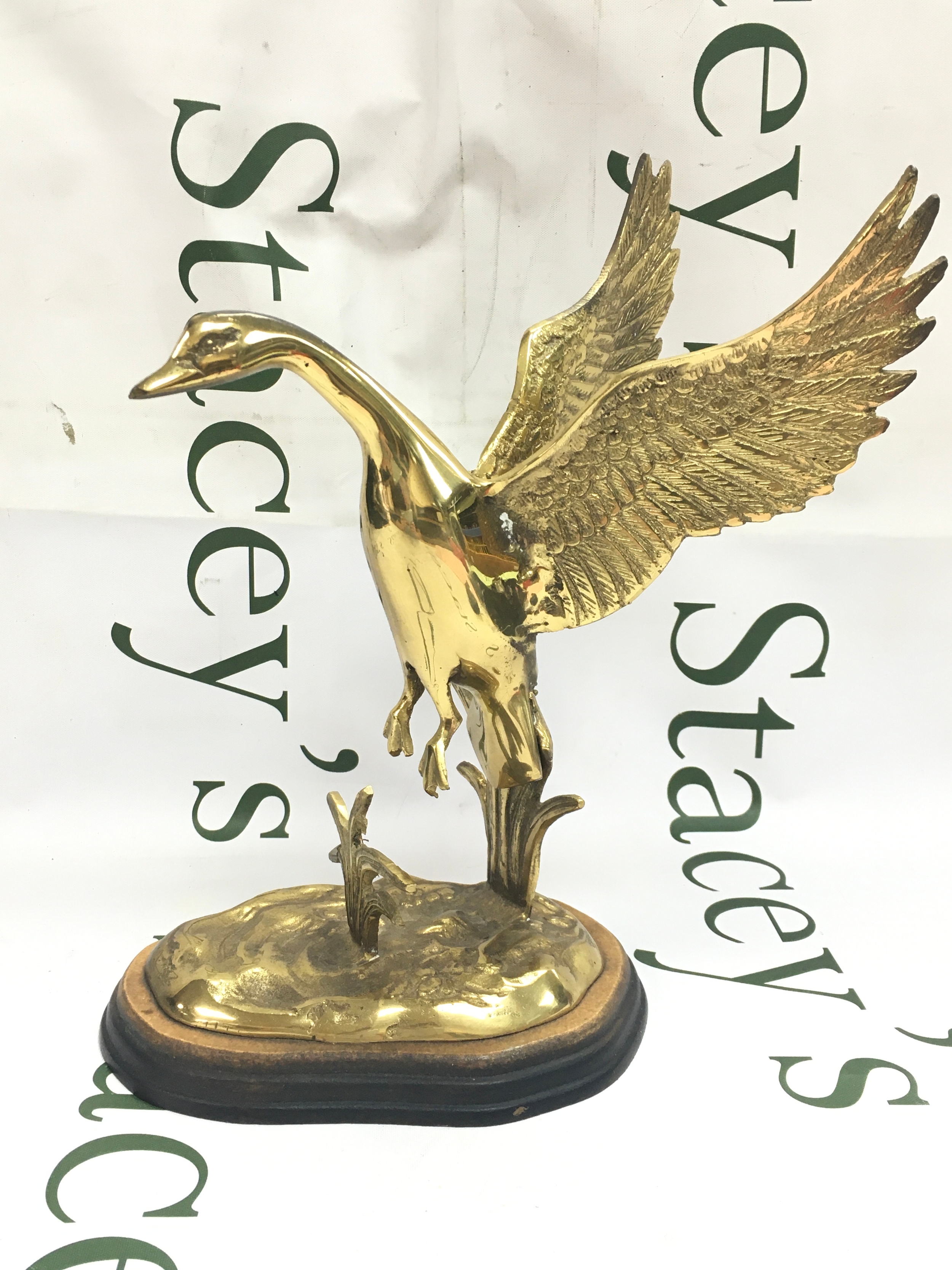 A brass figure of a goose in flight, 27cm tall
