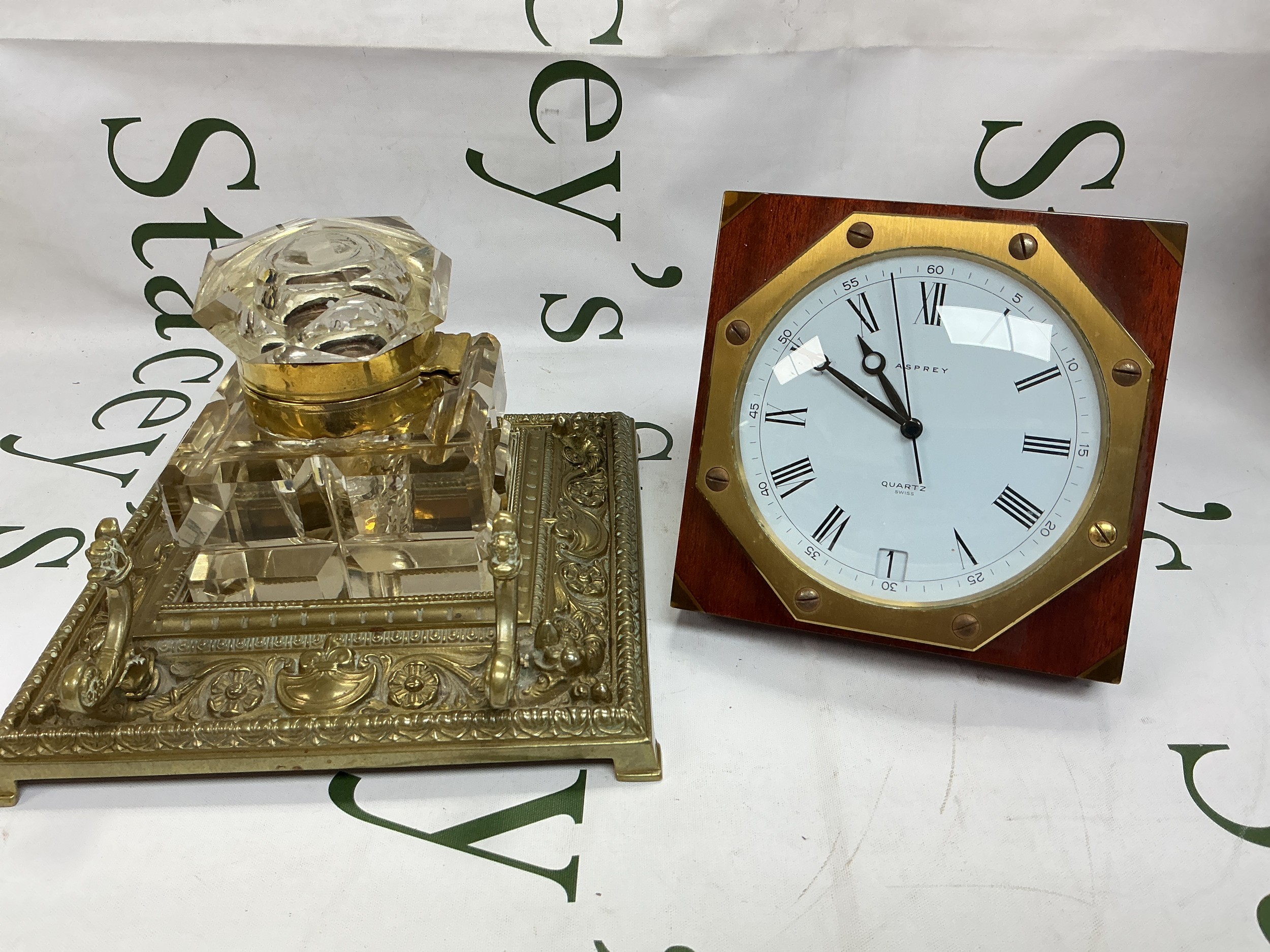 An Asprey desk clock and a large brass inkwell (2).