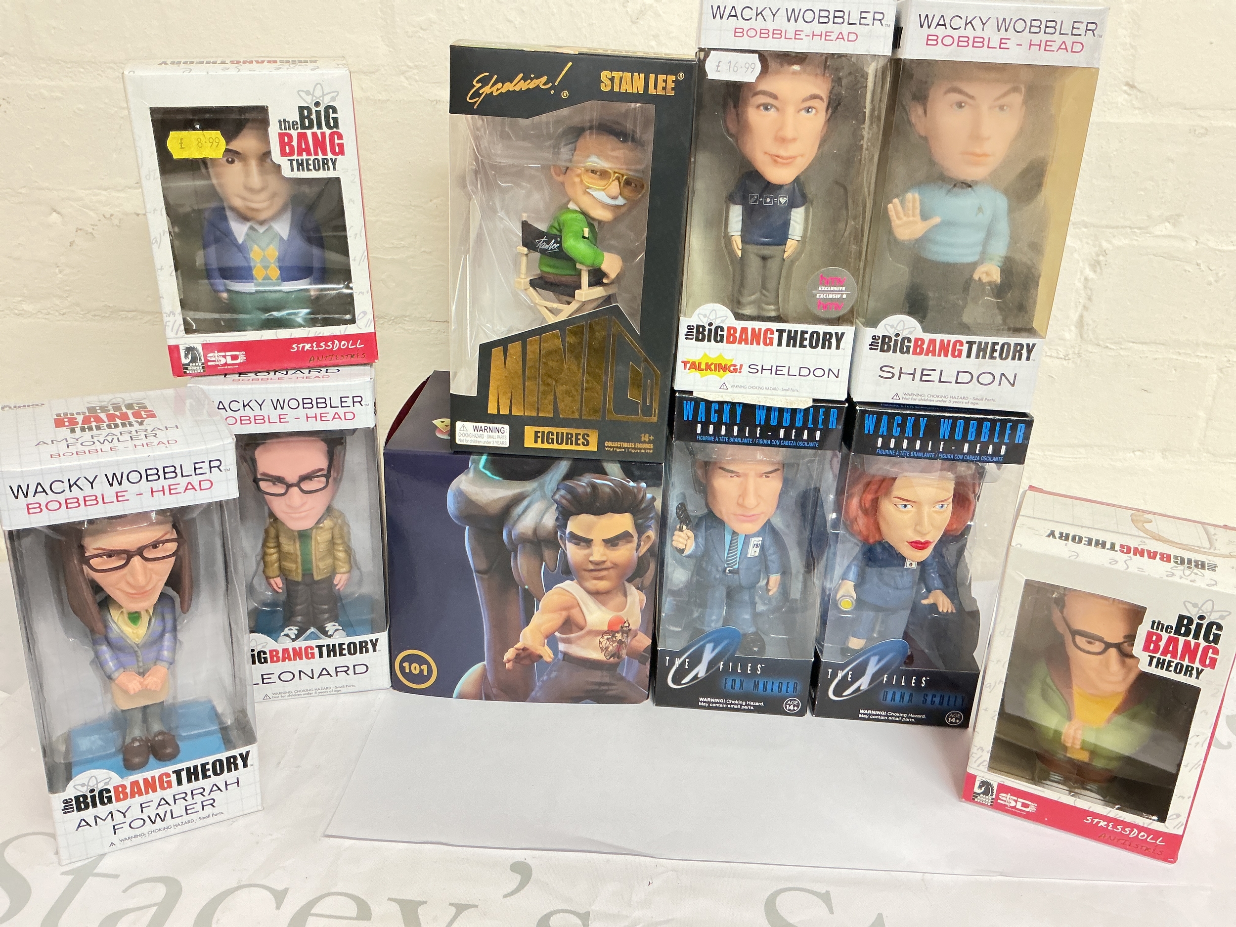 A Collection Of Boxed Bobble Heads And Other Boxed Figures Including A Iron Studios Stan Lee.