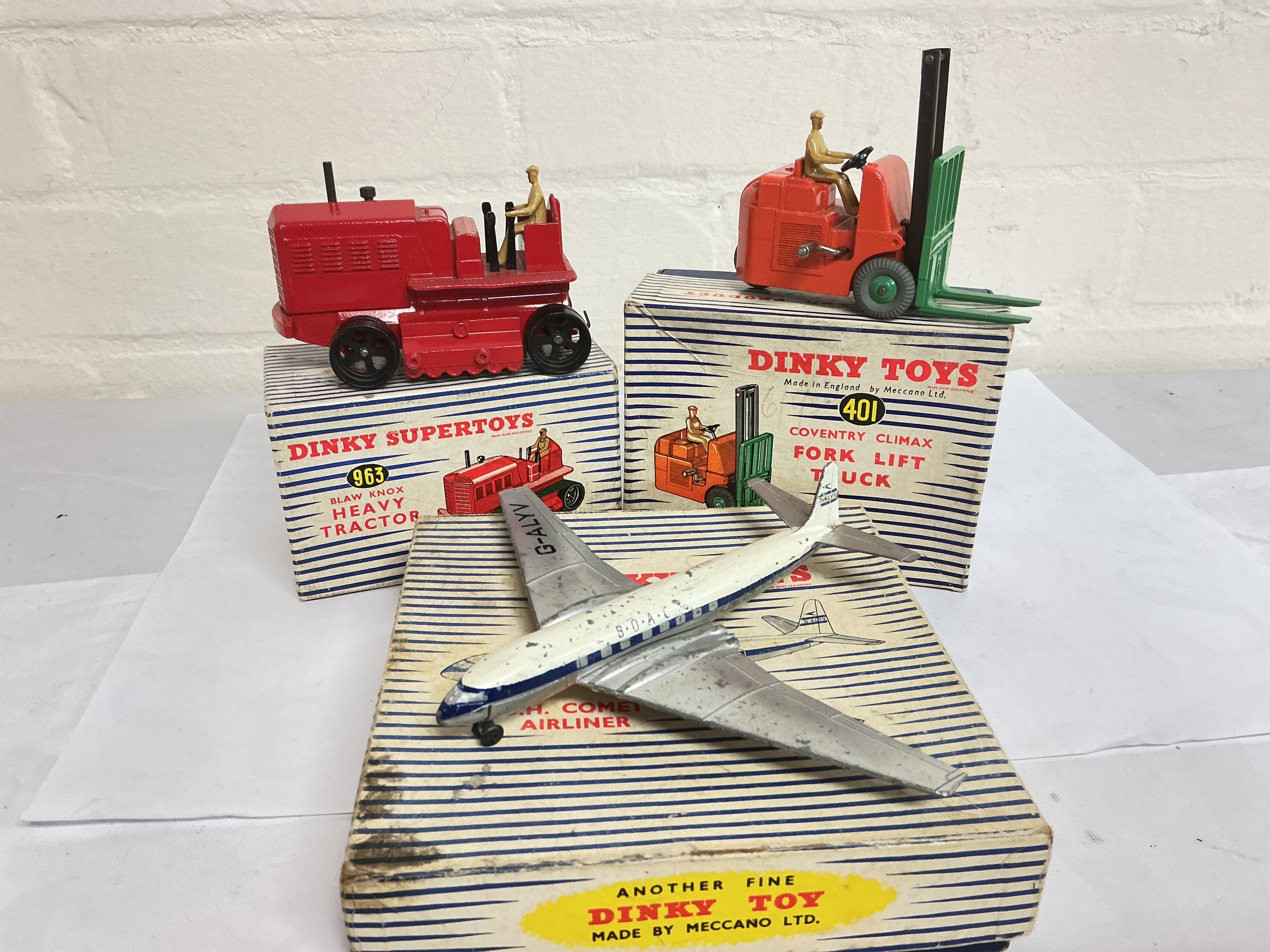 A Boxed Dinky Heavy Tractor #963, A Forklift Truck #401 And A D.H. Comet Airliner #702.No Reserve.
