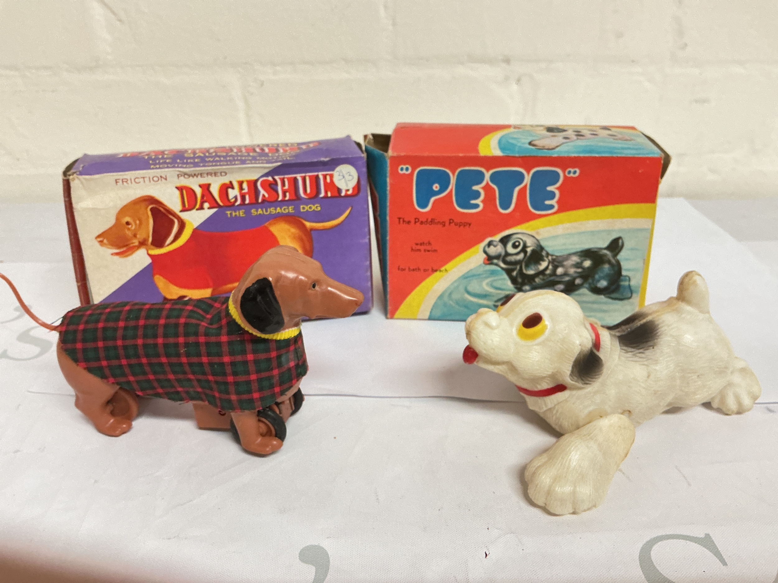  A Boxed Vintage Friction Powered, Toy Sausage Dog And A Paddling Puppy. No Reserve