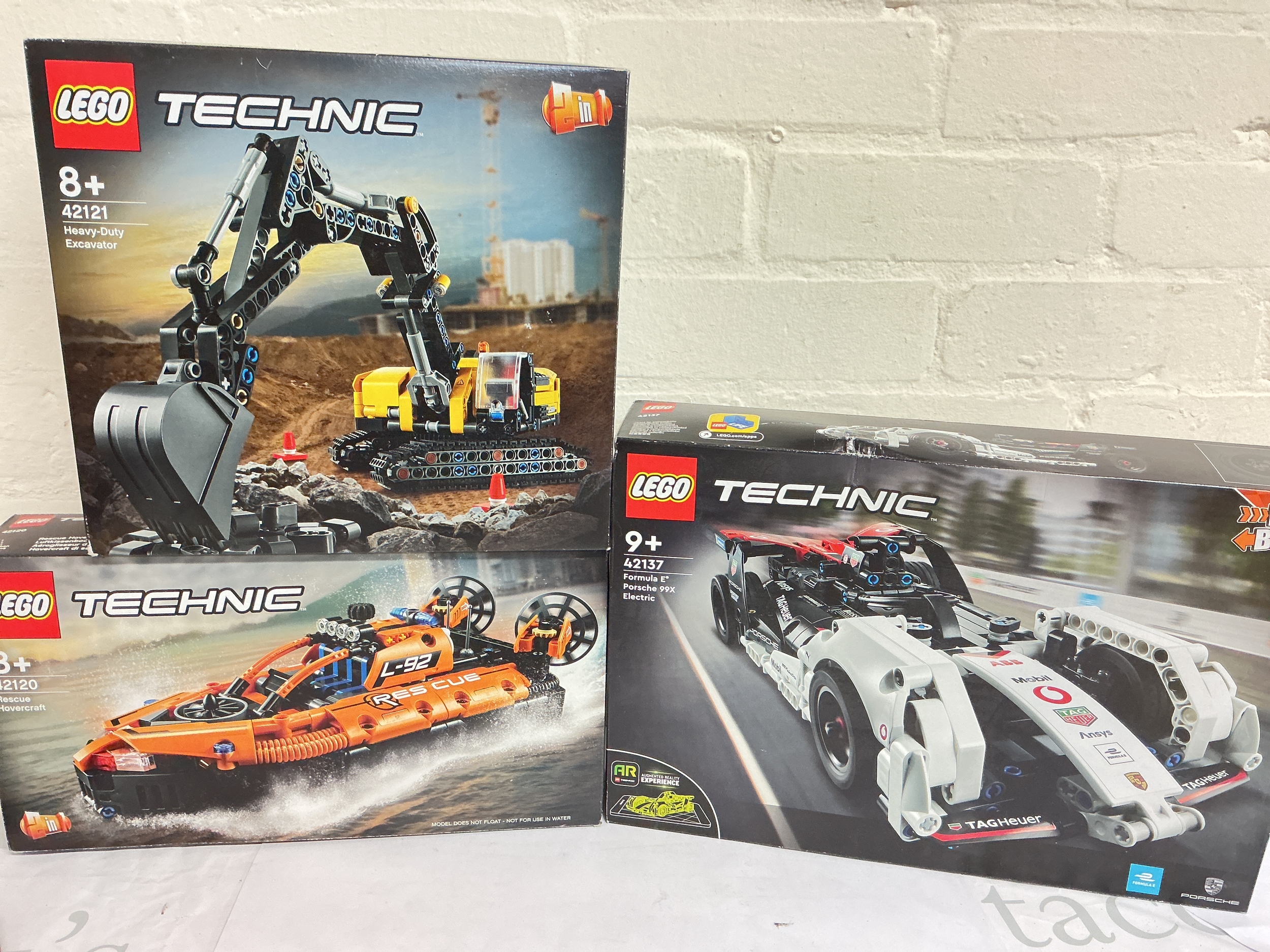 3 Boxed And Sealed Lego Technic Sets. A Heavy Duty Excavator #42121, A Rescue Hovercraft #42120 And A Formula E Porsche 99X Electric #42137. No Reserve.