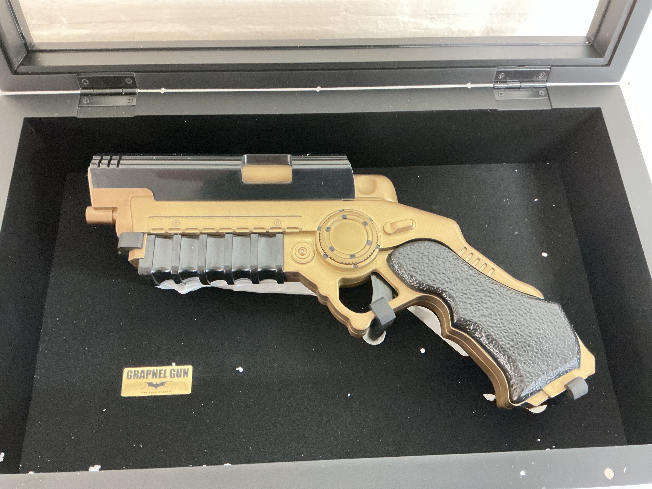 A Cased 1/1 Scale Replica Of The Dark Knights Grapnel Gun, By The Noble Collection. 