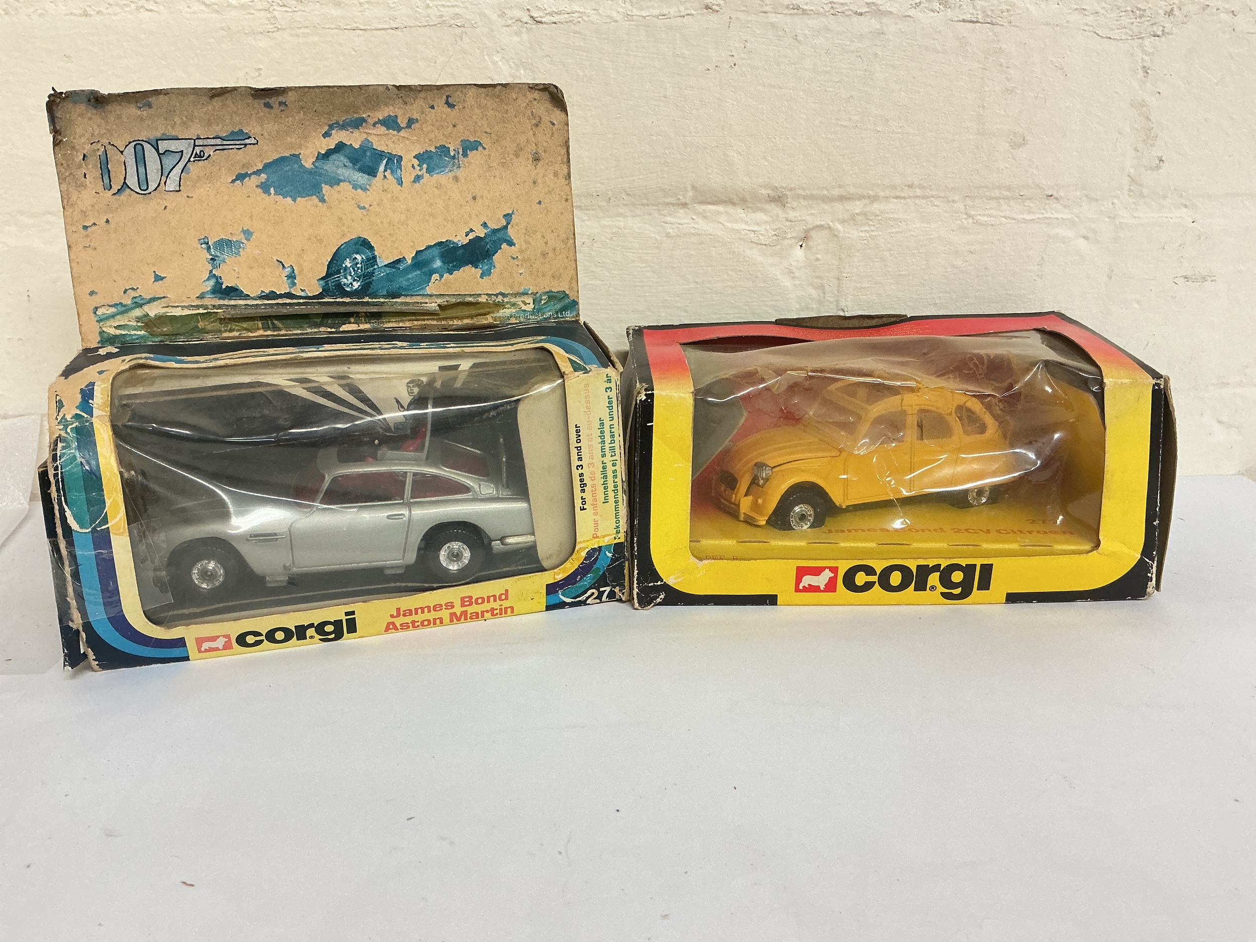 A Boxed Corgi James Bond Aston Martin #271 (Very Worn Box)  And A James Bond 2CV Citroen #272. No Reserve.