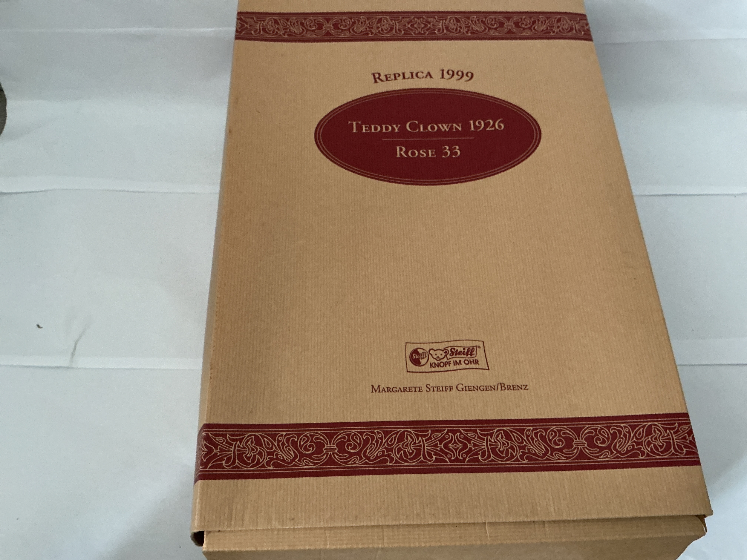 A Boxed 1999 Replica of The Teddy Clown 1926 Rose 33 Steiff Teddy Bear. Water Damage On Box. No Reserve.