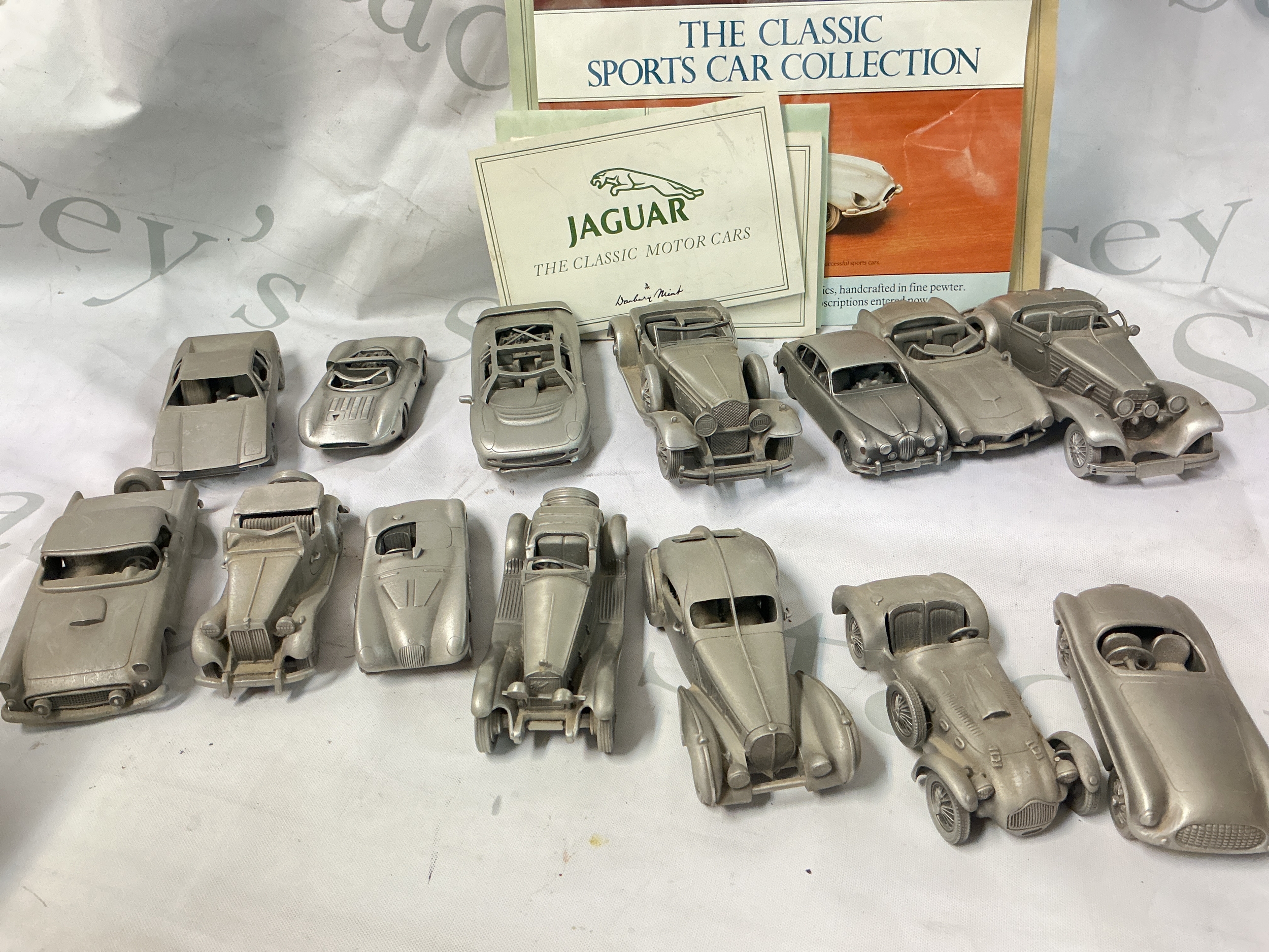 A Collection Of approximately 40 Danbury Mint Pewter Cars.