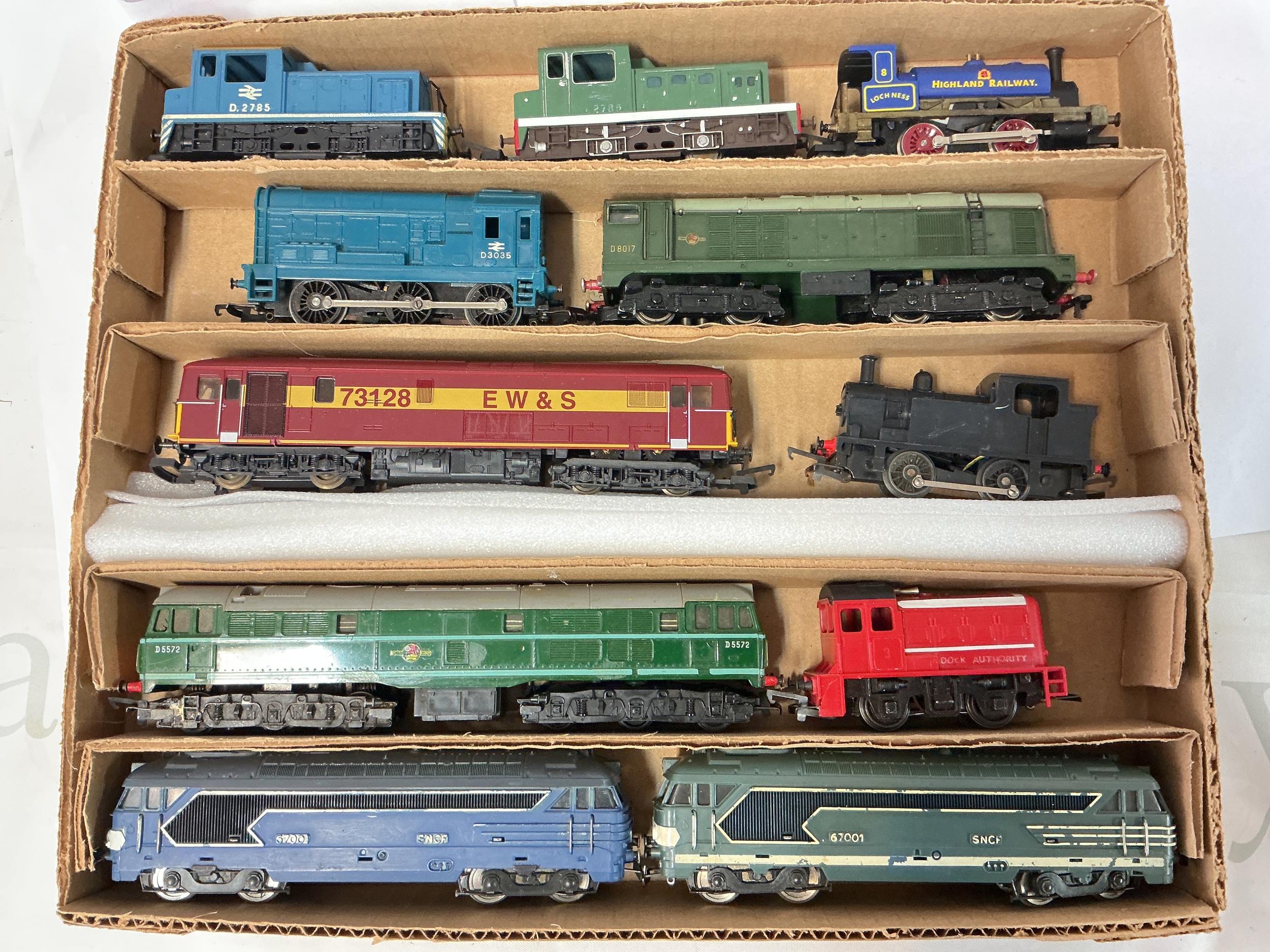 A Box Containing 11 00 Gauge Locomotives Including Tri-Ang, Lima Etc. No Reserve.