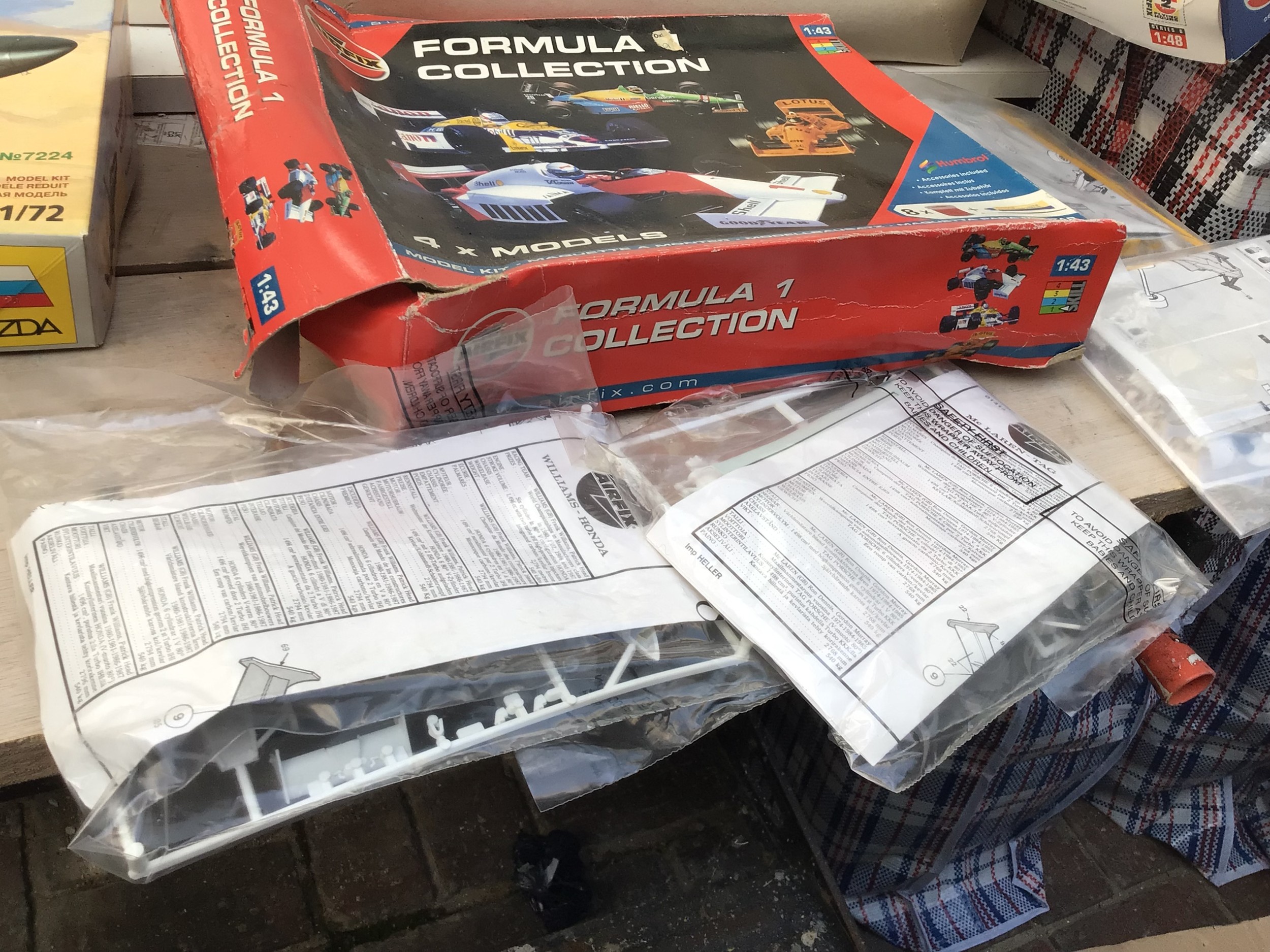 A box containing a collection of boxed model kits by various manufacturers including Airfix, Kitech, Revell etc. collection consists of mainly aircraft with cars in a variety of scales.  No reserve.