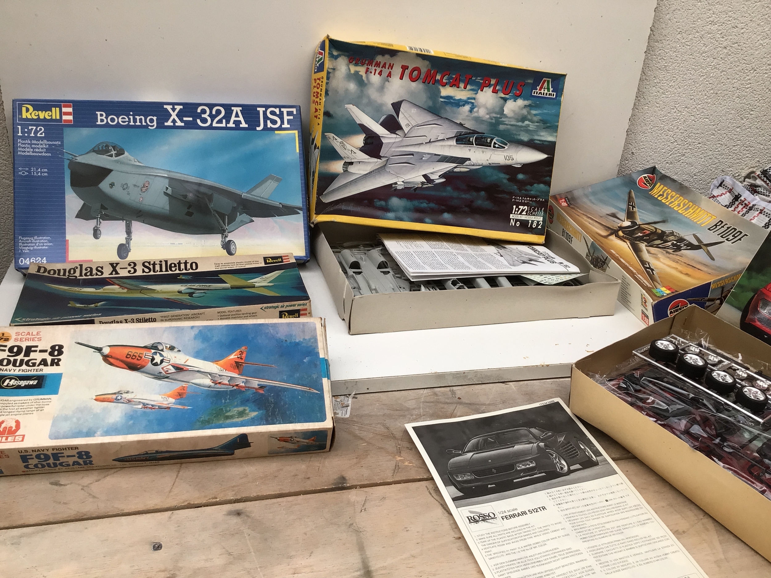 A collection of boxed model kits by Revell, Italeri, Airfix in a variety of scales, featuring aircraft and cars.  No reserve