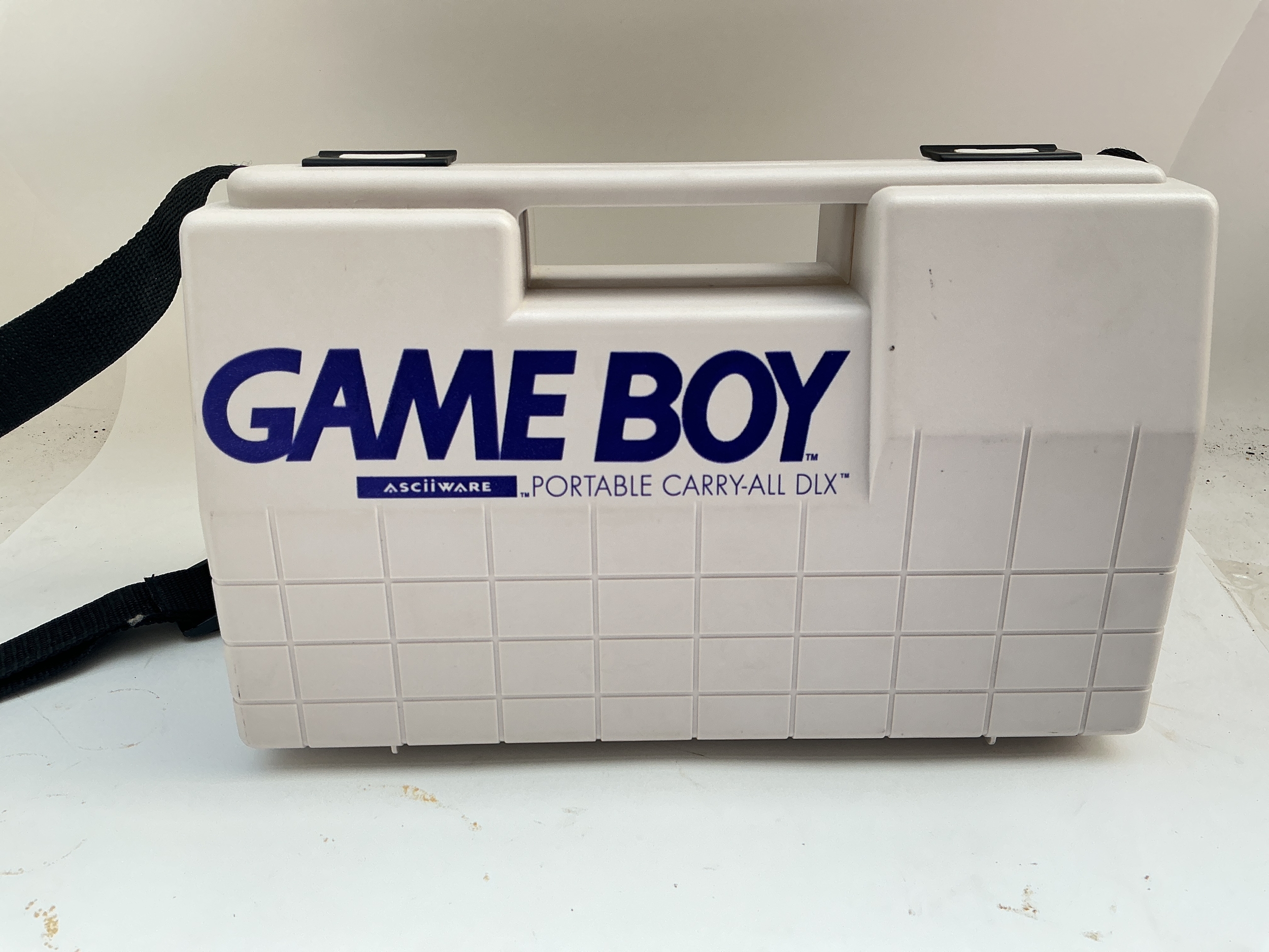 A Nintendo Gameboy In Carry Case.