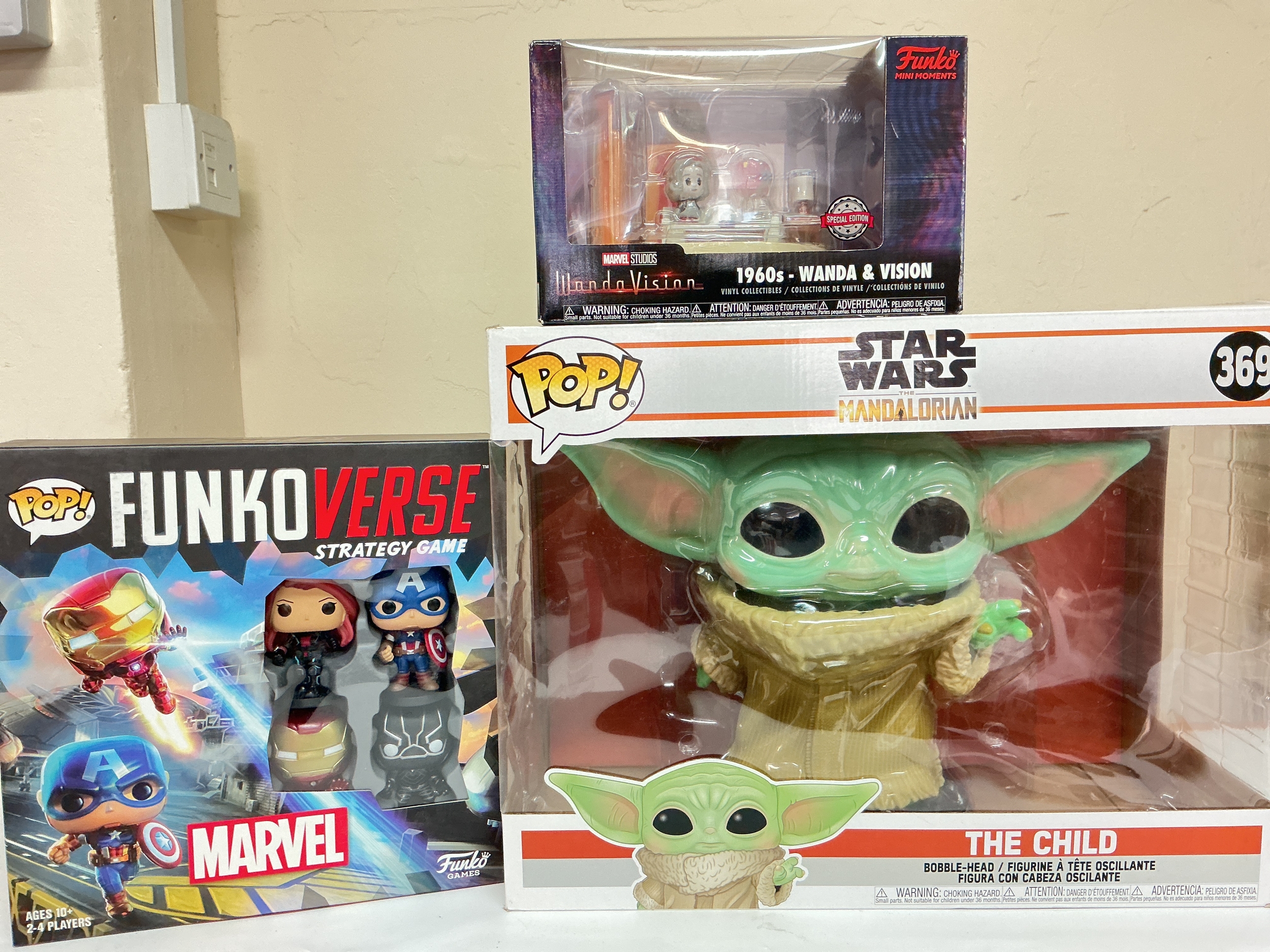 A Boxed Large Funko The Mandalorian The Child Figure, A Funkoverse Strategy Game And A Wanda Vision Set.