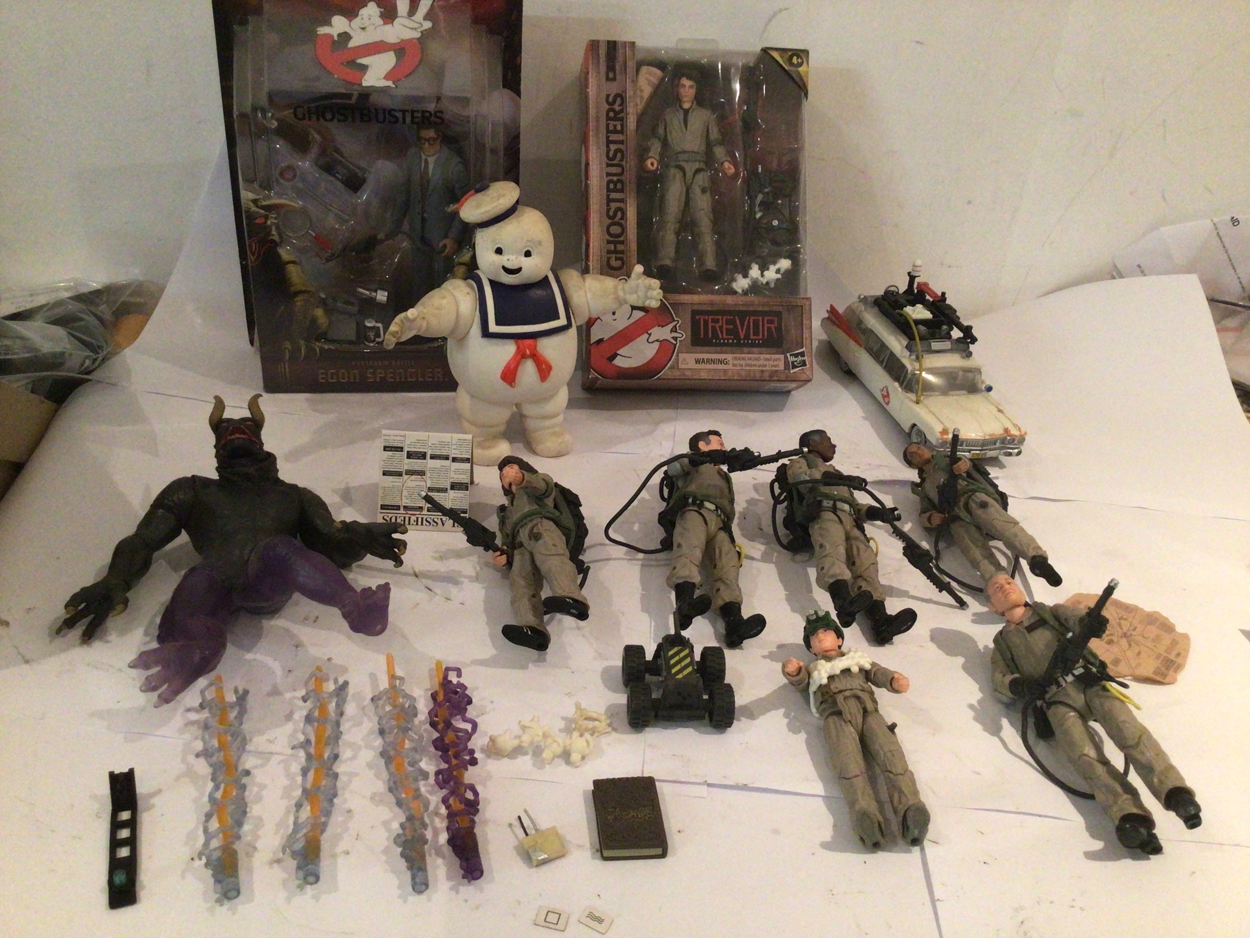 A collection of Ghostbusters figures including 2x in original unopened packaging.  Includes vintage and modern pieces.  No reserve