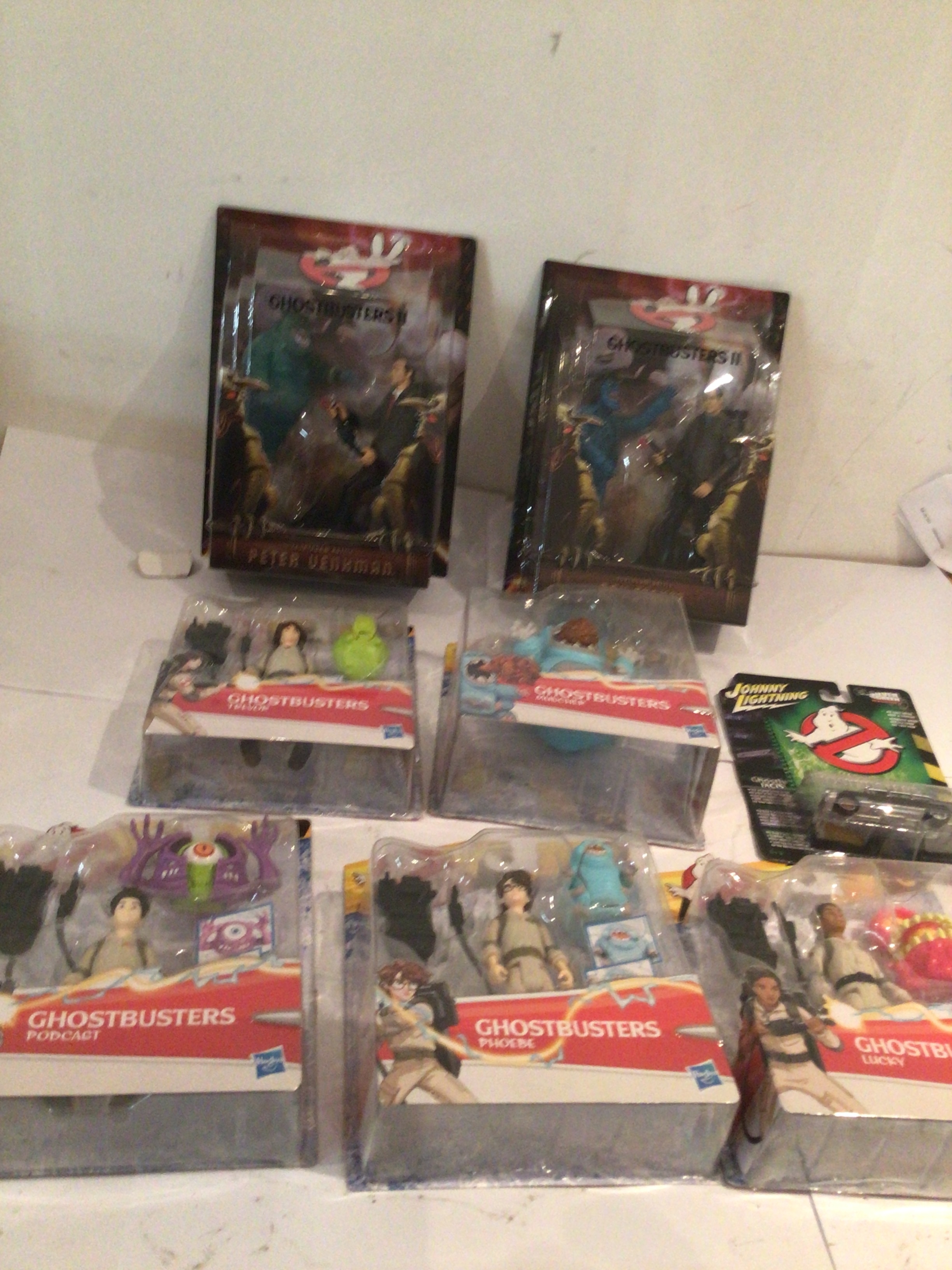 A collection of Ghostbusters action figures including 2x in their original unopened packaging, includes figures from the courtroom.  Also includes Johnny lightening car.  No reserve