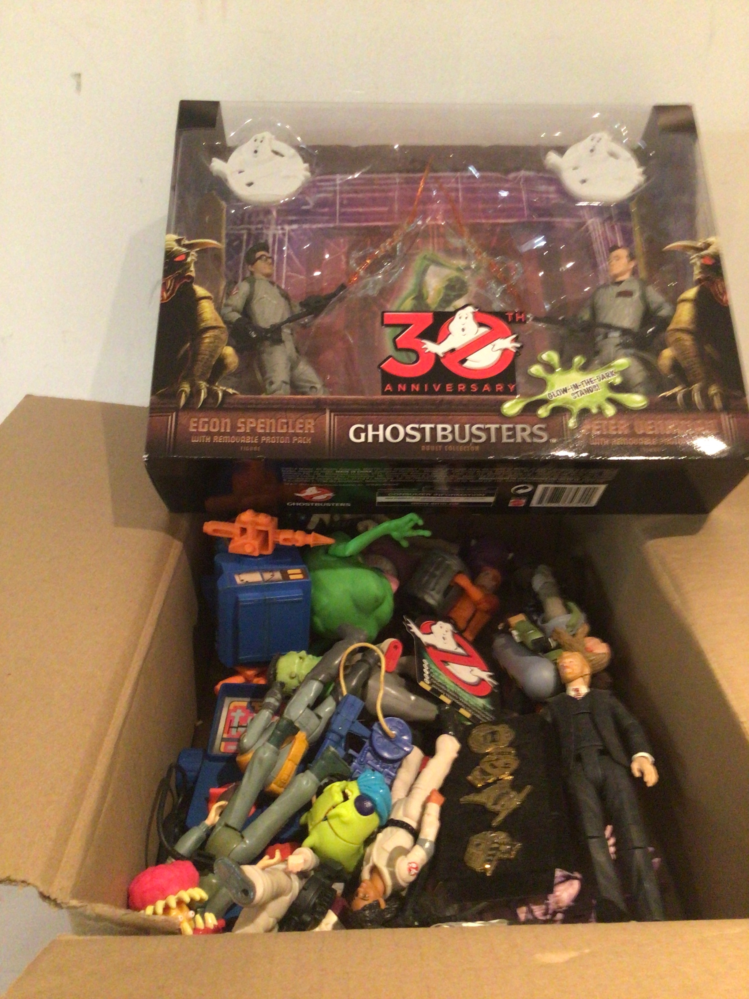 A box of loose Ghostbusters characters and accessories, also includes boxed 30th anniversary Egon and Peter action figures with proton packs.  No reserve.