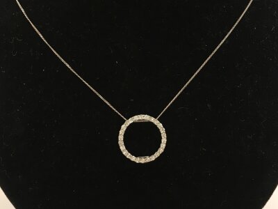 A 9ct white gold necklace with a CZ pendant.
