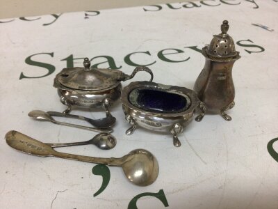 A silver condiments with silver mustard spoons including a George III silver mustard spoon.
