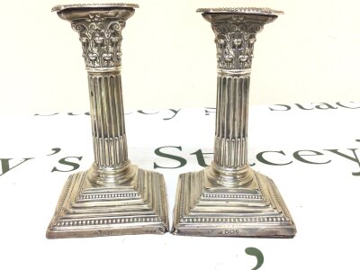 A Pair of silver Corinthian column candle sticks loaded bases Sheffield hallmarks hight 15cm