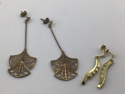 Two pairs of 9cart gold earrings in the form of open scroll fans and one other pair of drop earrings each set with CZ. Weight 6.5g