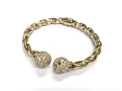 A hollow 9ct gold CZ set twist bangle. Approx weight 18.42 grams.