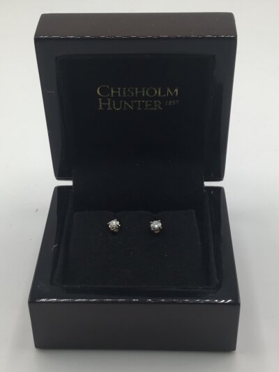 A Pair of gold diamond stud earrings brilliant cut possible 0.2 of a carat.