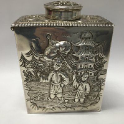 A Georgian silver tea caddy of rectangular form featuring detailed oriental scenes to the foursides depicting figures pagoda flowers and foliage 11 cm dated 1766 London maker Pierre Gilloils , 317 grams.
