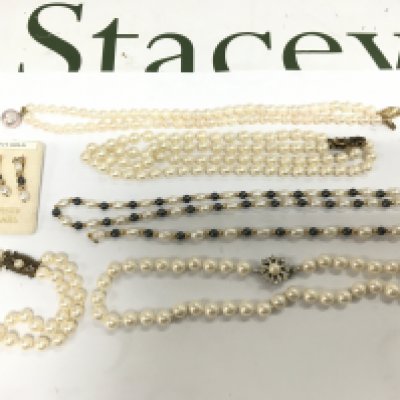 A small collection of pearl necklaces, some with gold clasps.