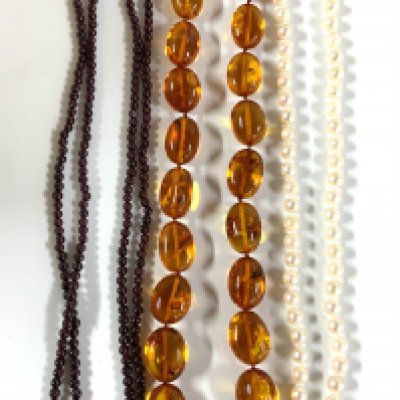 A vintage Amber bead necklace, cultured pearl necklace, eastern garnet and gilt bead necklace. NO RESERVE