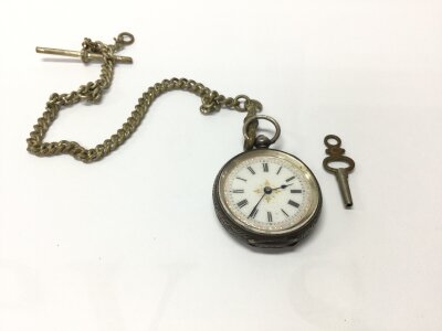 A silver cased ladies pocket fob watch. Approximately 36mm case. Winds and runs.